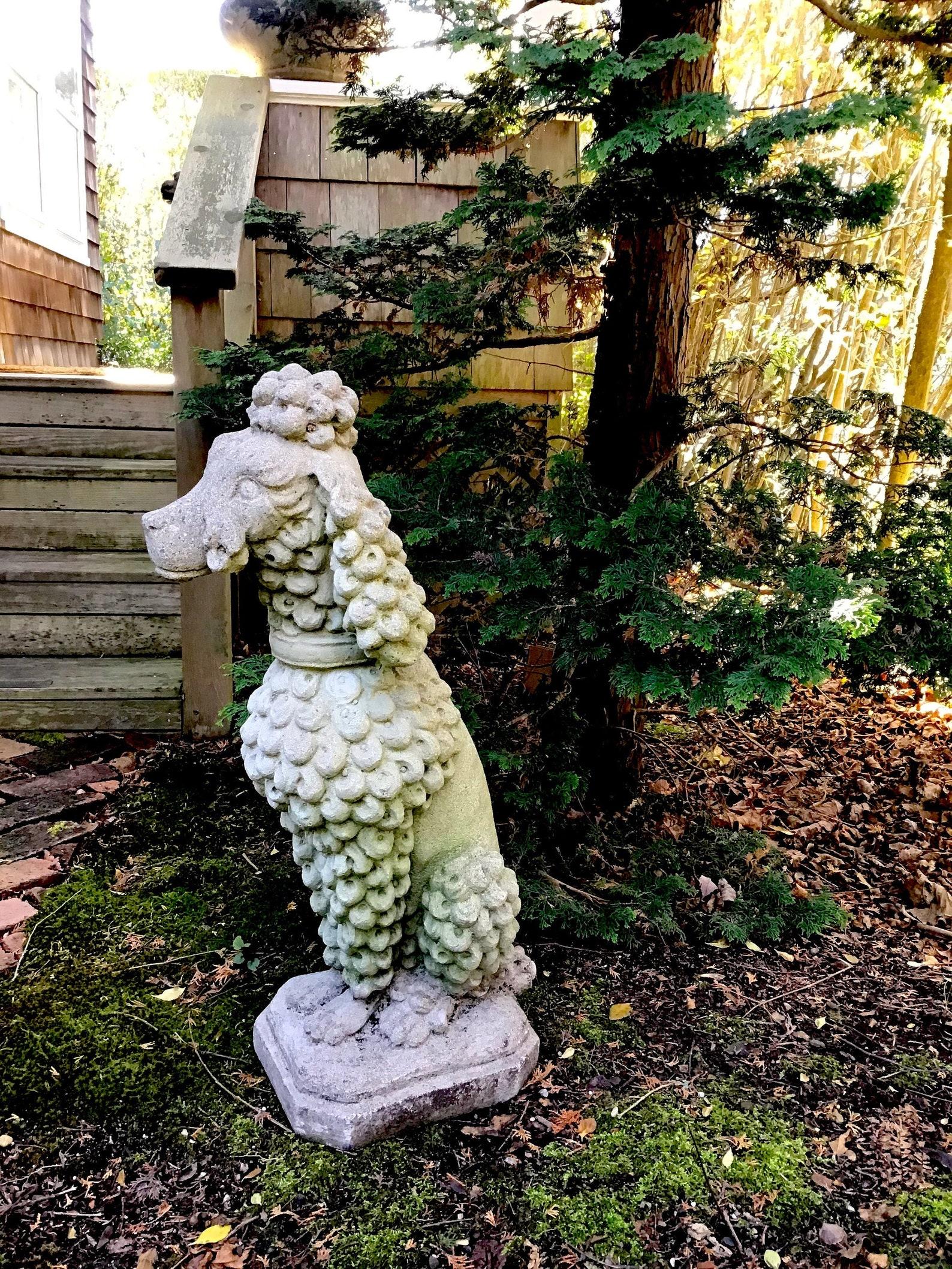 Mid century cement dog, French poodle, vintage garden statue.
Vintage French poodle is most probably a 1950's reproduction of a very old french design, in cast cement.
 