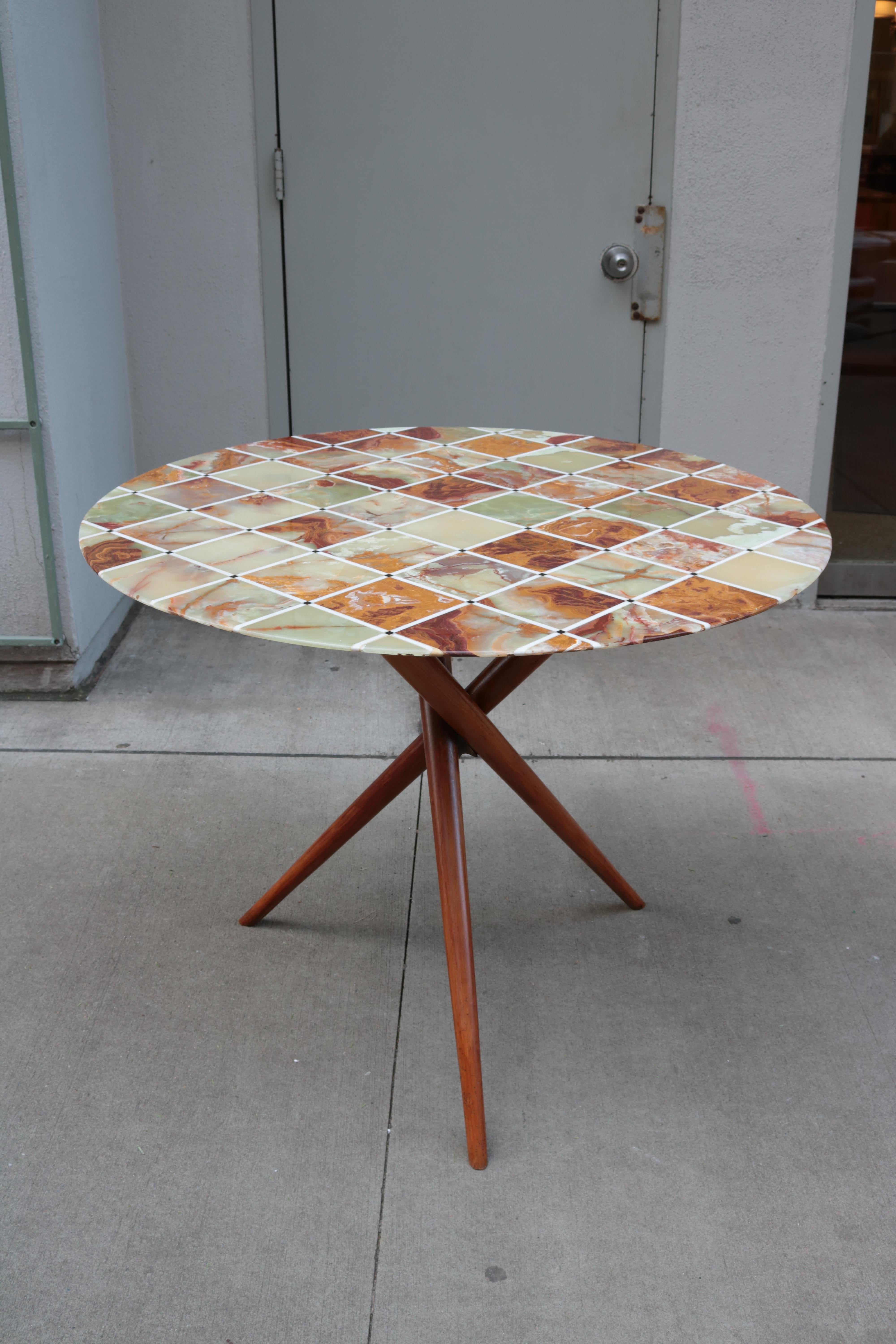 Midcentury center table with fine Inlaid stone top.
Wooden tripod base.
