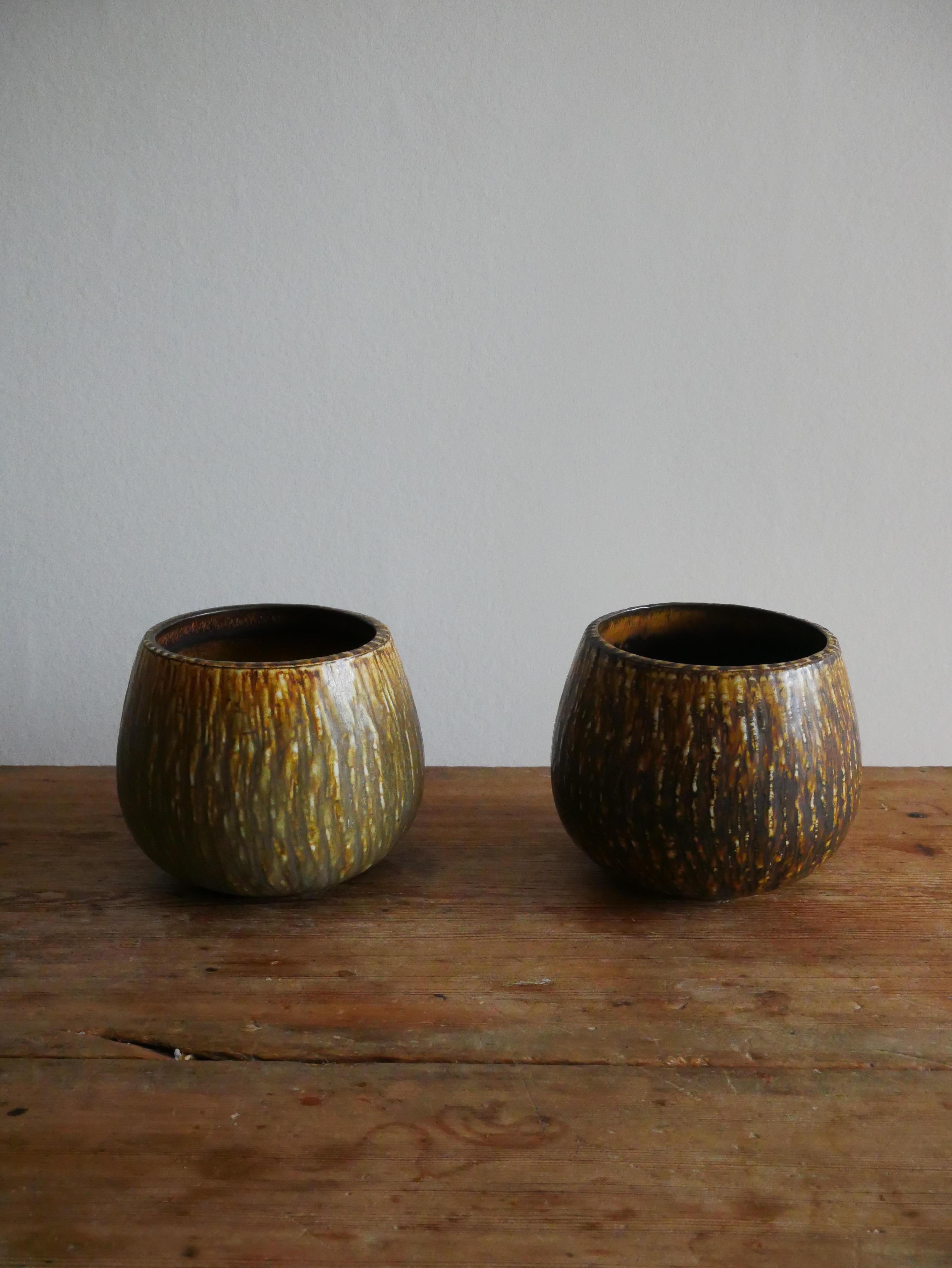 Set of Two Ceramic Pieces, Rubus, Gunnar Nylund, Rörstrand, Sweden.

The bowls has a silky, textured surface with brown, green and yellow colors and faint glaze with a matt finish. Great condition and first quality. 

Sell as a pair.

