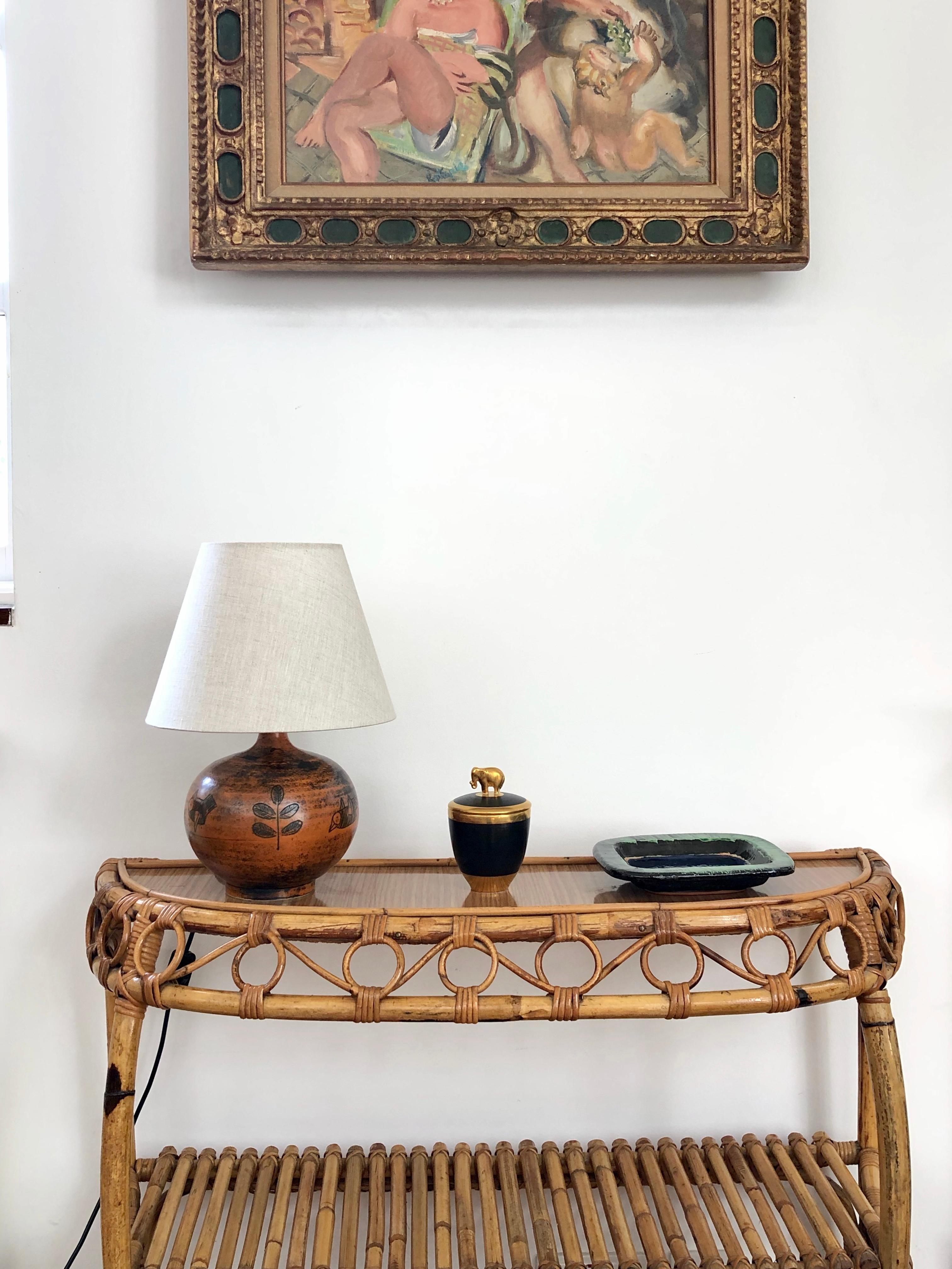 Midcentury ceramic table lamp (circa 1950s) by Jacques Blin. This beautifully rust-colored French lamp (circa 1950s) with sgraffito-etched leaves and birds is in very good vintage condition commensurate with age. Highly collectible. The shade is not