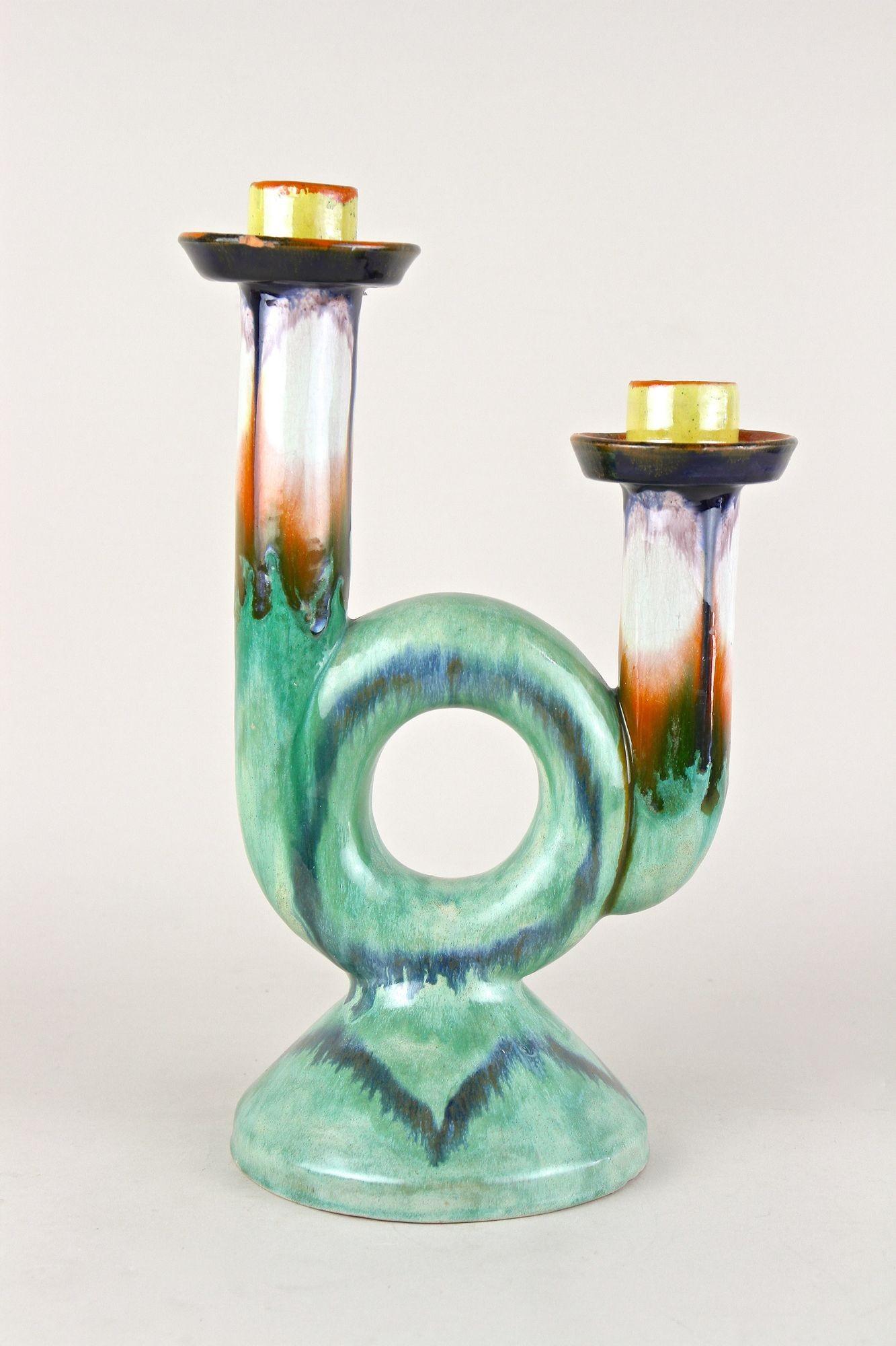 Extraordinary mid century ceramic candle holder from the period around 1950 in Austria. This out of the ordinary designed candle holder impresses with its amazing looking shape and the beautiful colored 