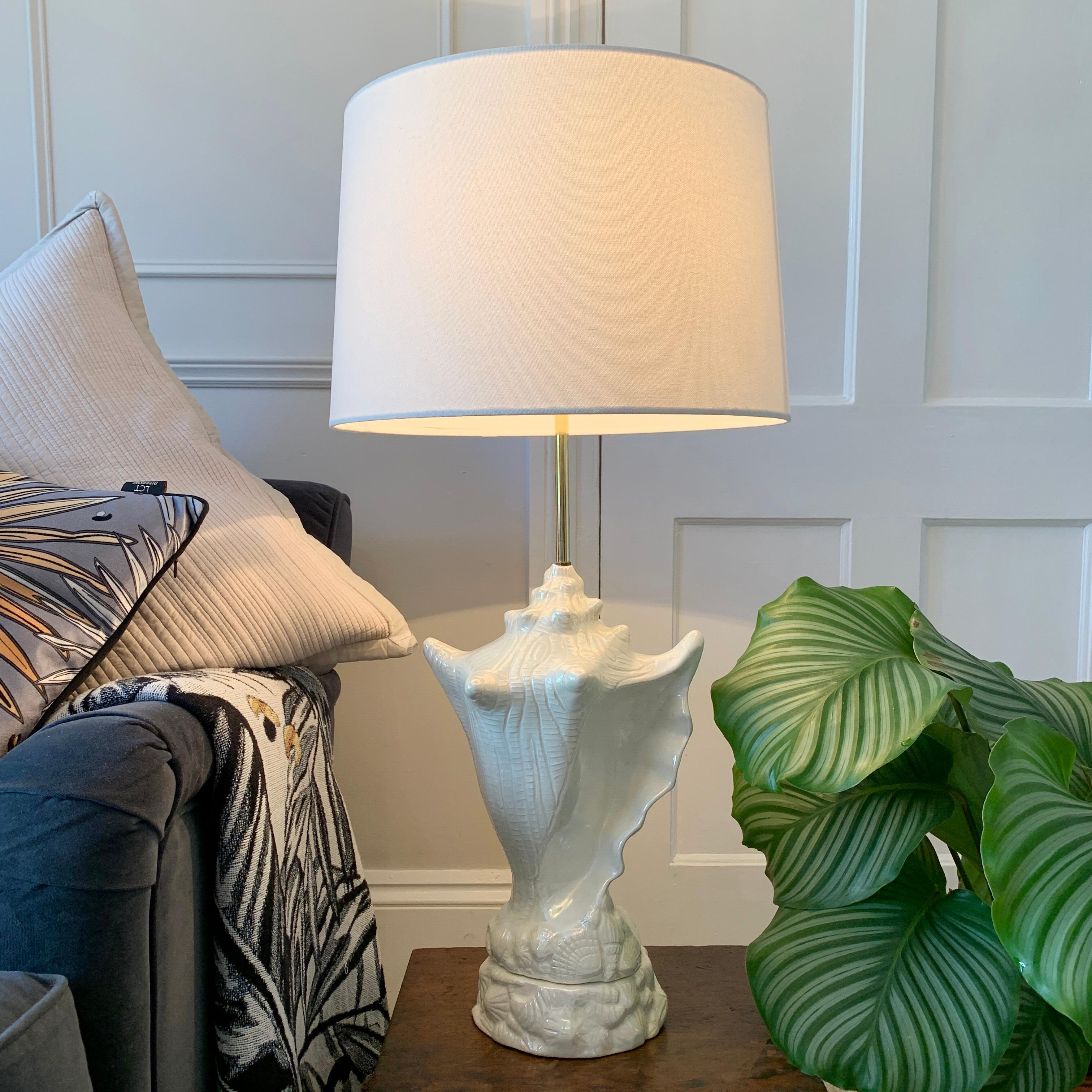 Fantastic mid century ceramic conch shell table lamp
C 1960's / 70's
This large sized ceramic conch shell is finished in an off white colour with iridescent glaze, the finish gives a soft rainbow of colour as the light catches it
The main conch