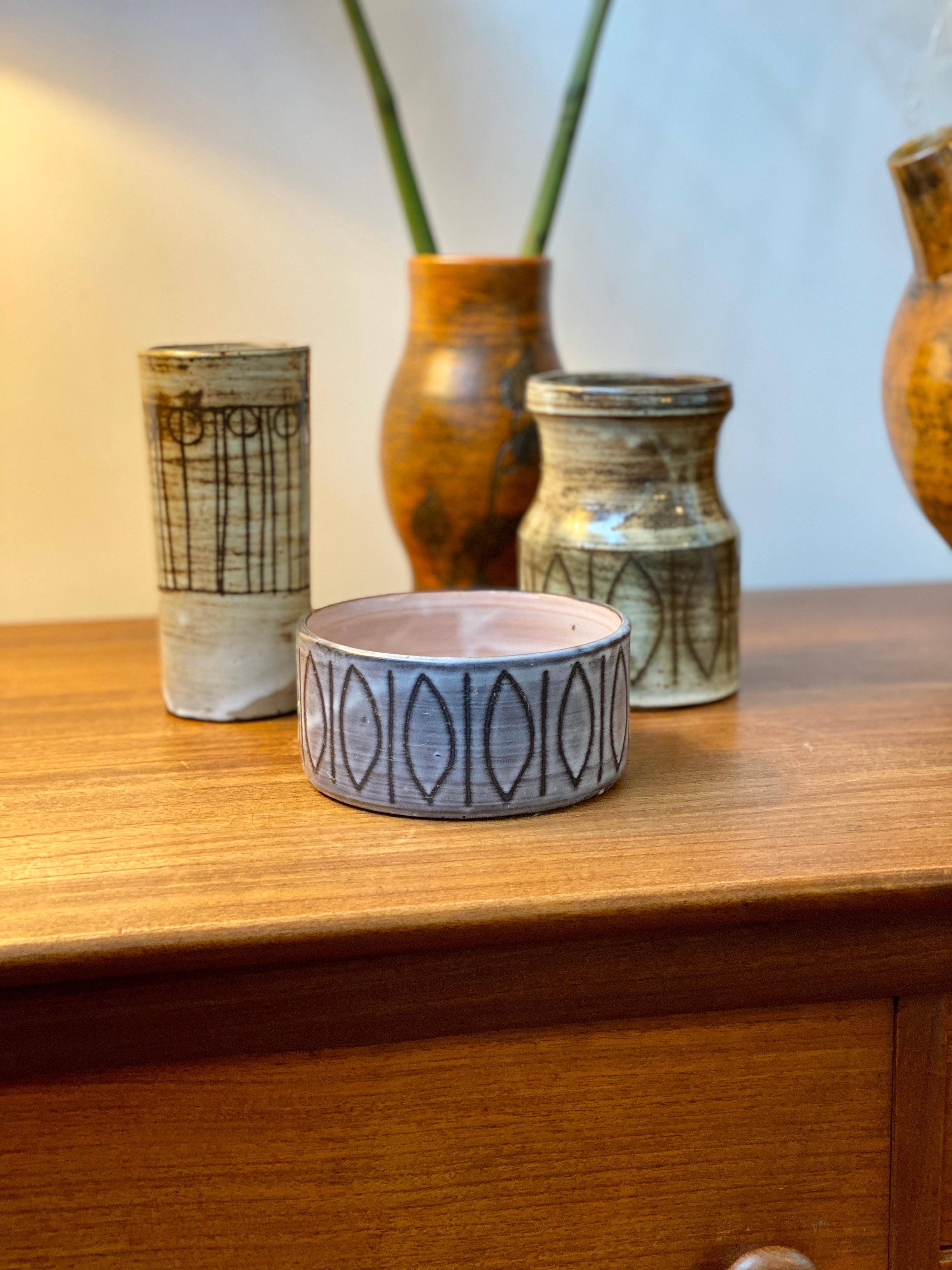 Midcentury ceramic 'dog bowl'-shaped dish by Jacques Pouchain / Atelier Dieulefit (circa 1960s). This small decorative deep dish could also be used as a vide-poche. It is in Pouchain's signature cloudy glaze style but with rare grey-toned hues. It