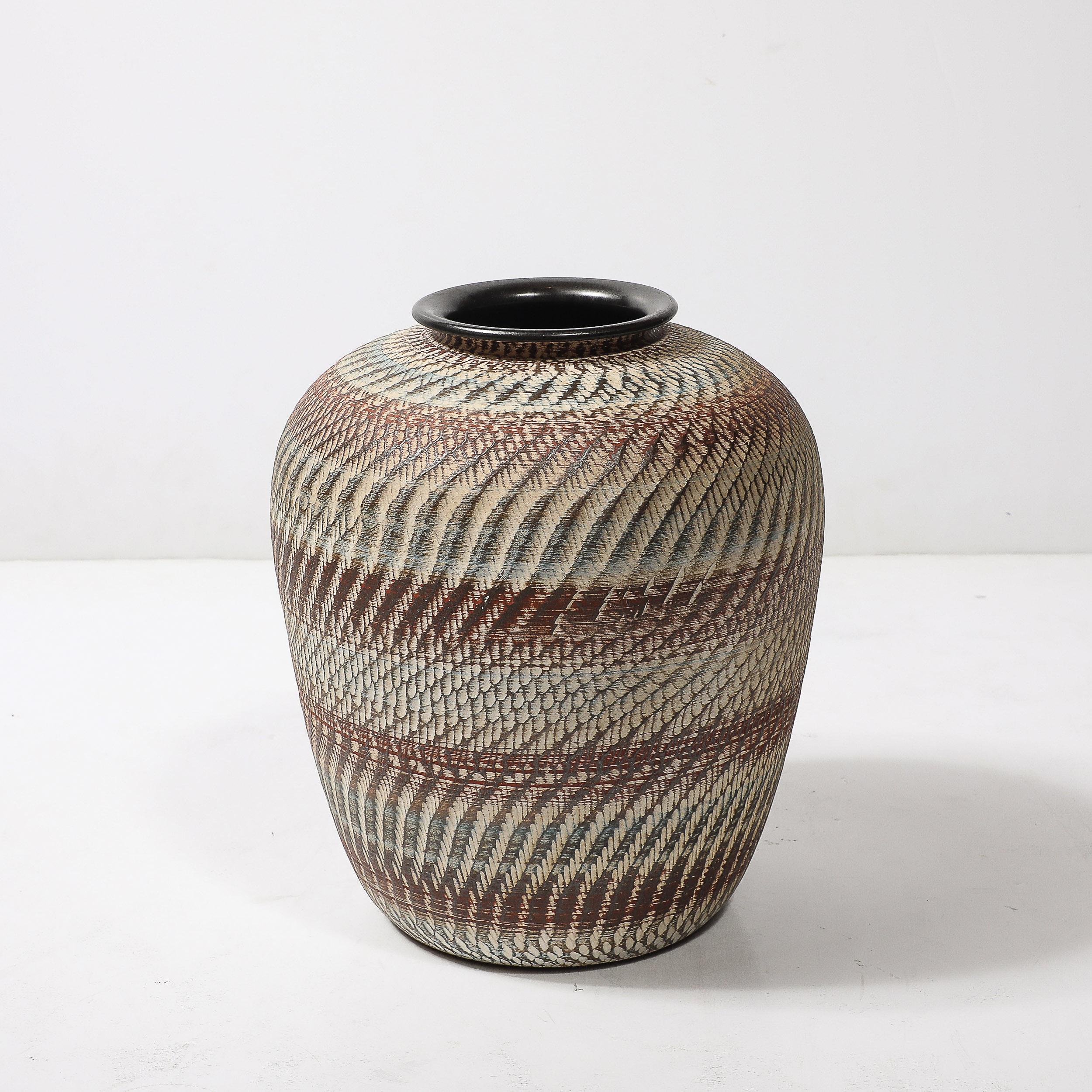 This exceptional mid-century modernist ceramic vase showcases a scaled textural design achieved through a reductive method, where carefully patterned grooves remove material from the surface, creating a striking interplay of texture and depth. The