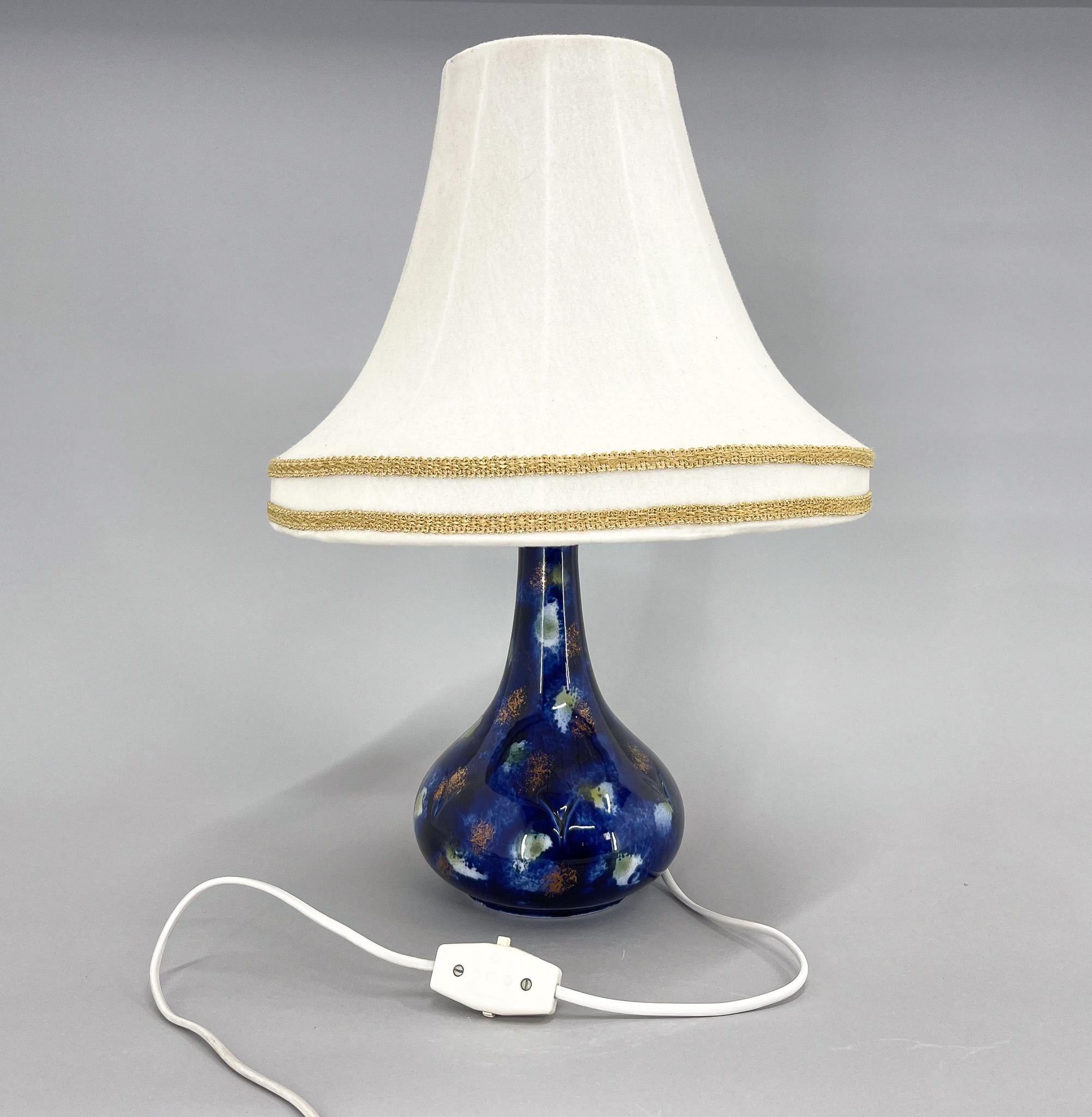 Unusual vintage table lamp from former Czechoslovakia with ceramic base and original fabric lamp shade. Bulb: E25-E27.