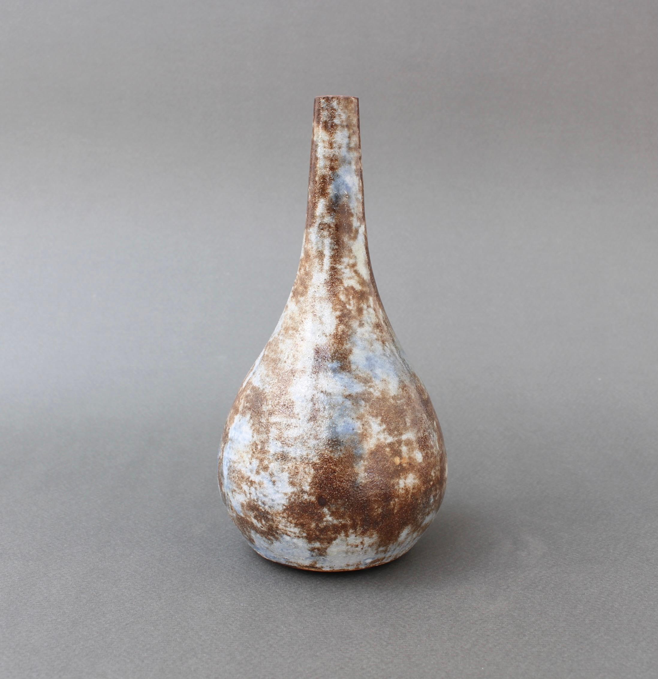 Mid-century ceramic flower vase by Alexandre Kostanda (circa 1960s). Stunning form in this earthenware vessel which reveals the artist's trademark misty appearance with earth tones in brown, beige and delicate blues. Tactile and visually alluring,