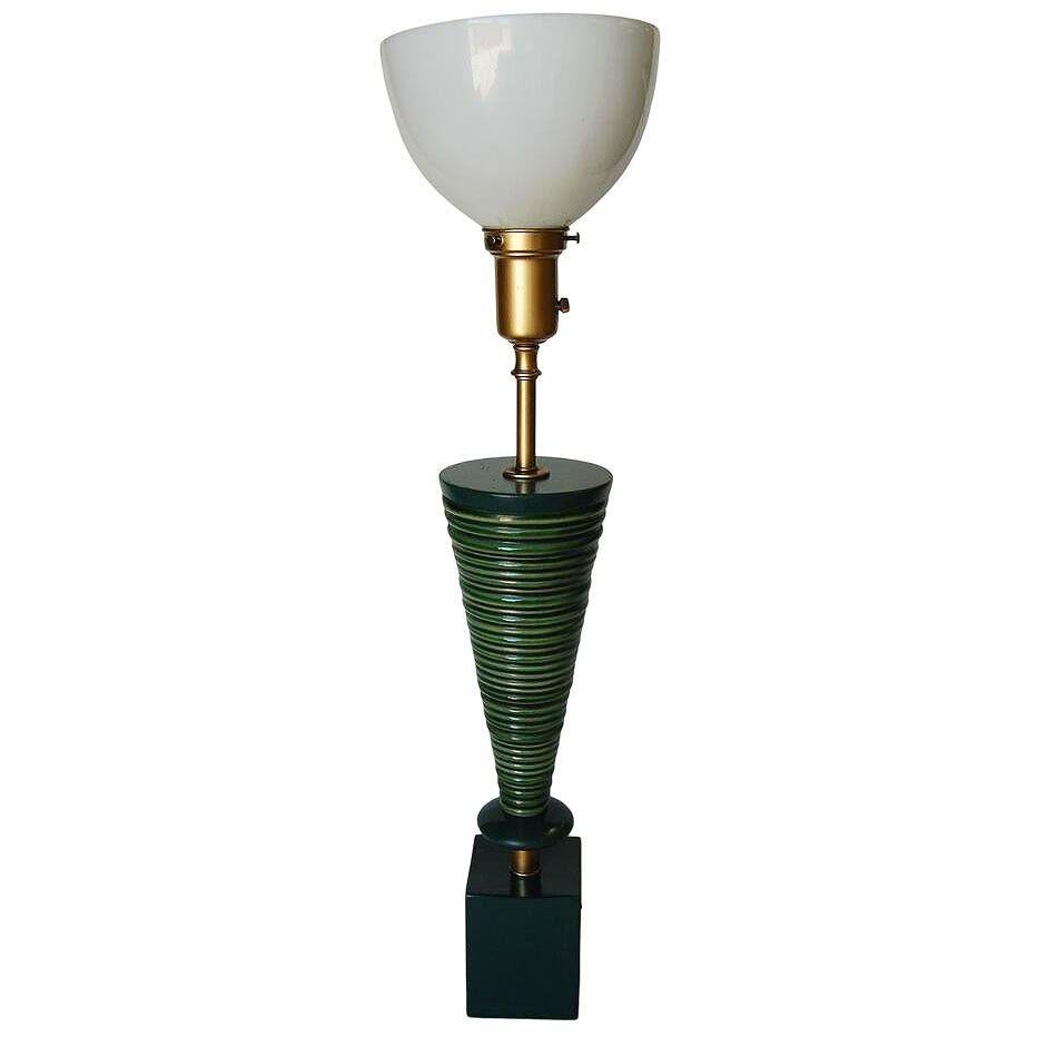 A pair of 2 geometric Modernist table lamps labeled by the Rembrandt lighting company. Each lamp features a green ceramic spiral cone shape fixed to a black lacquer wood block base. They both come with their original milk glass shades.

Measures 4