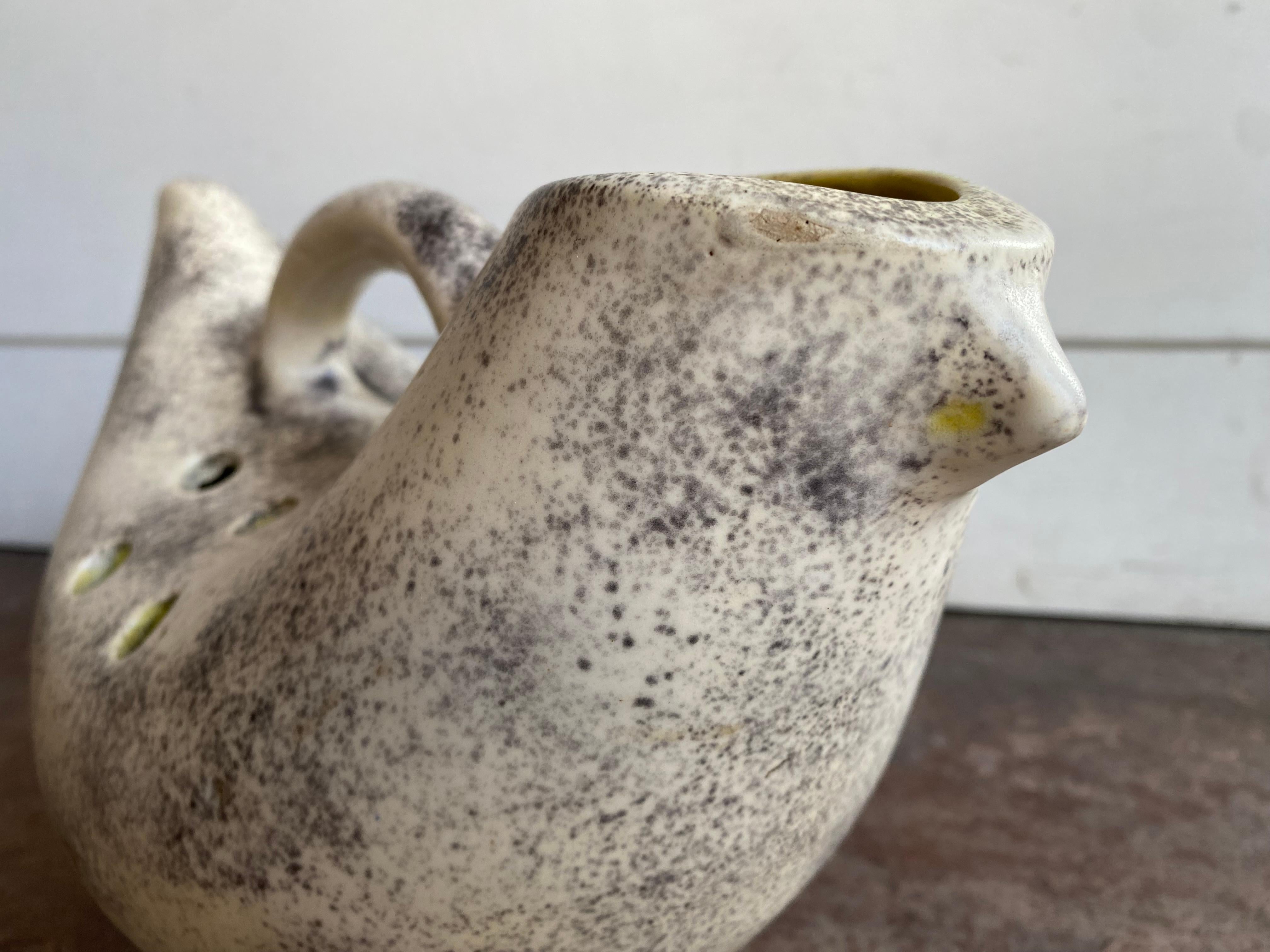 This unique ceramic sculpture immerses us in a world where the modernist design of the mid-20th century intersects with the ancient echoes of early civilizations. Its refined, stylized form suggests a creature that is part animal, part mythical,