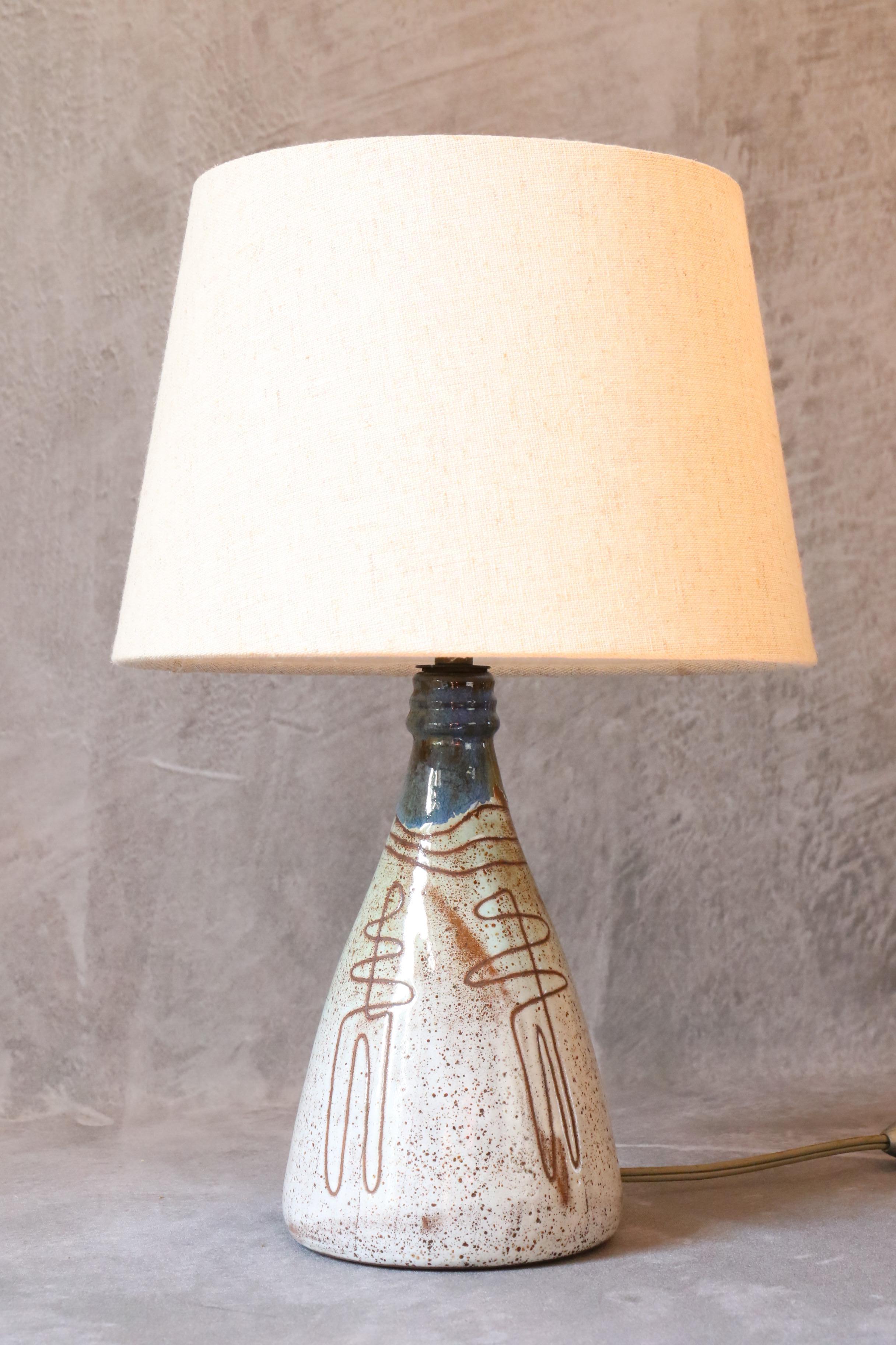 Mid-Century Ceramic Lamp by Jean Rivier, 1950's, Vallauris, France

A beautiful milky white and blue glazed ceramic lamp. 
Signed below: 