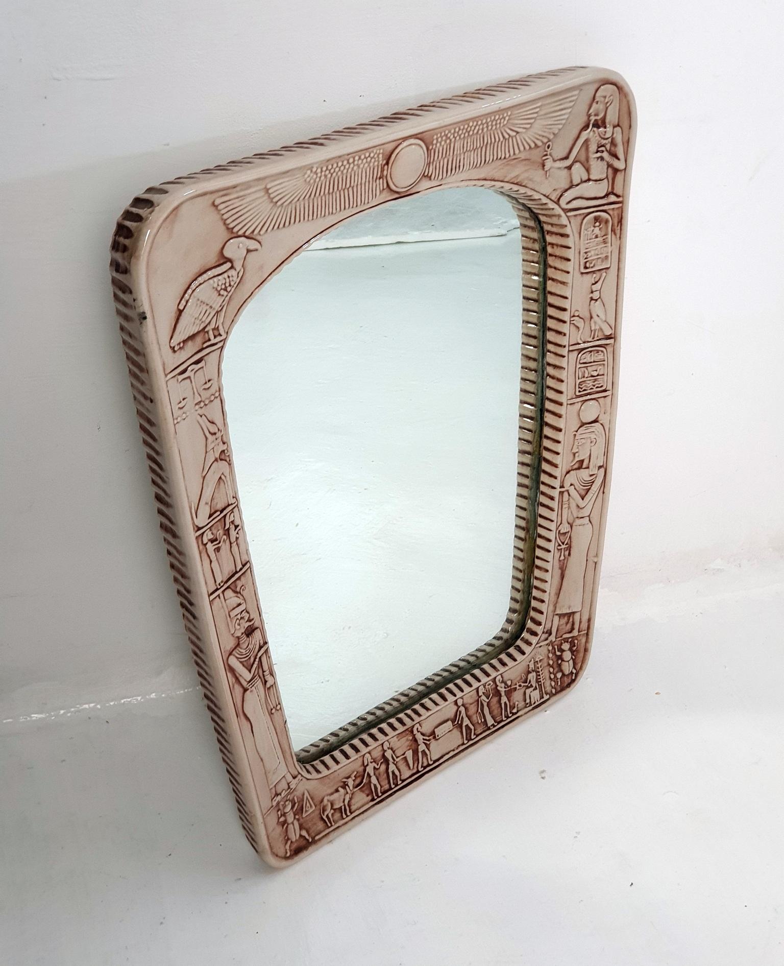 This Italian ceramic mirror, dating back to the late 1960s, showcases a unique and captivating design. The frame of the mirror is crafted from handmade ceramic, with bevelled edges on the sides. However, its true charm lies in the front, where