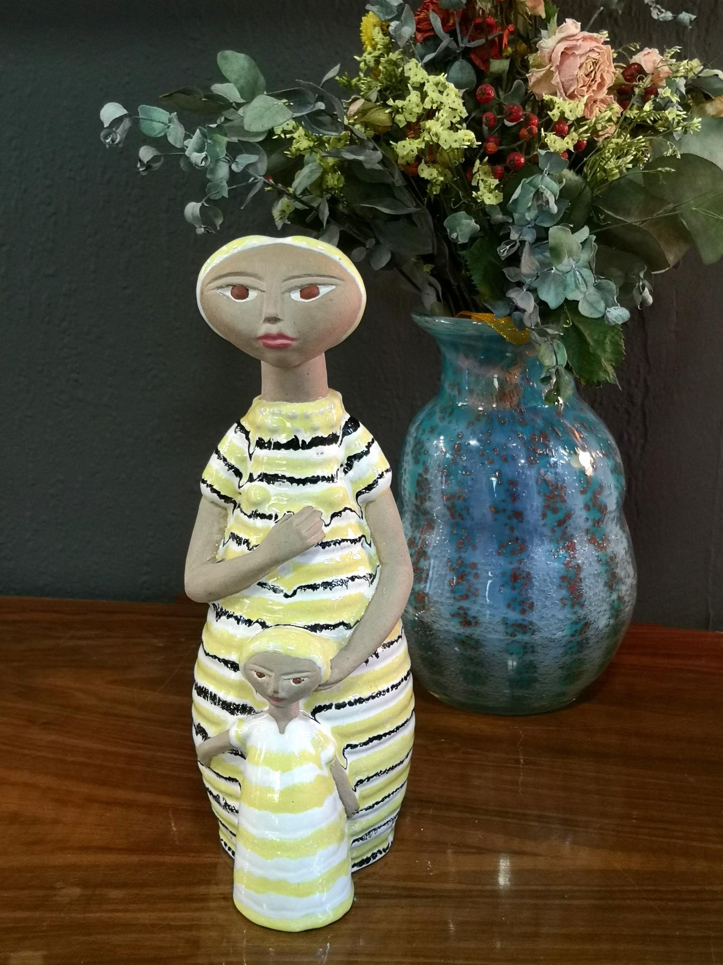 Lovely colorful hand-made ceramic sculpture of a mother with her daughter, from the 1970s. It's markes Slakta, and is in great condition.