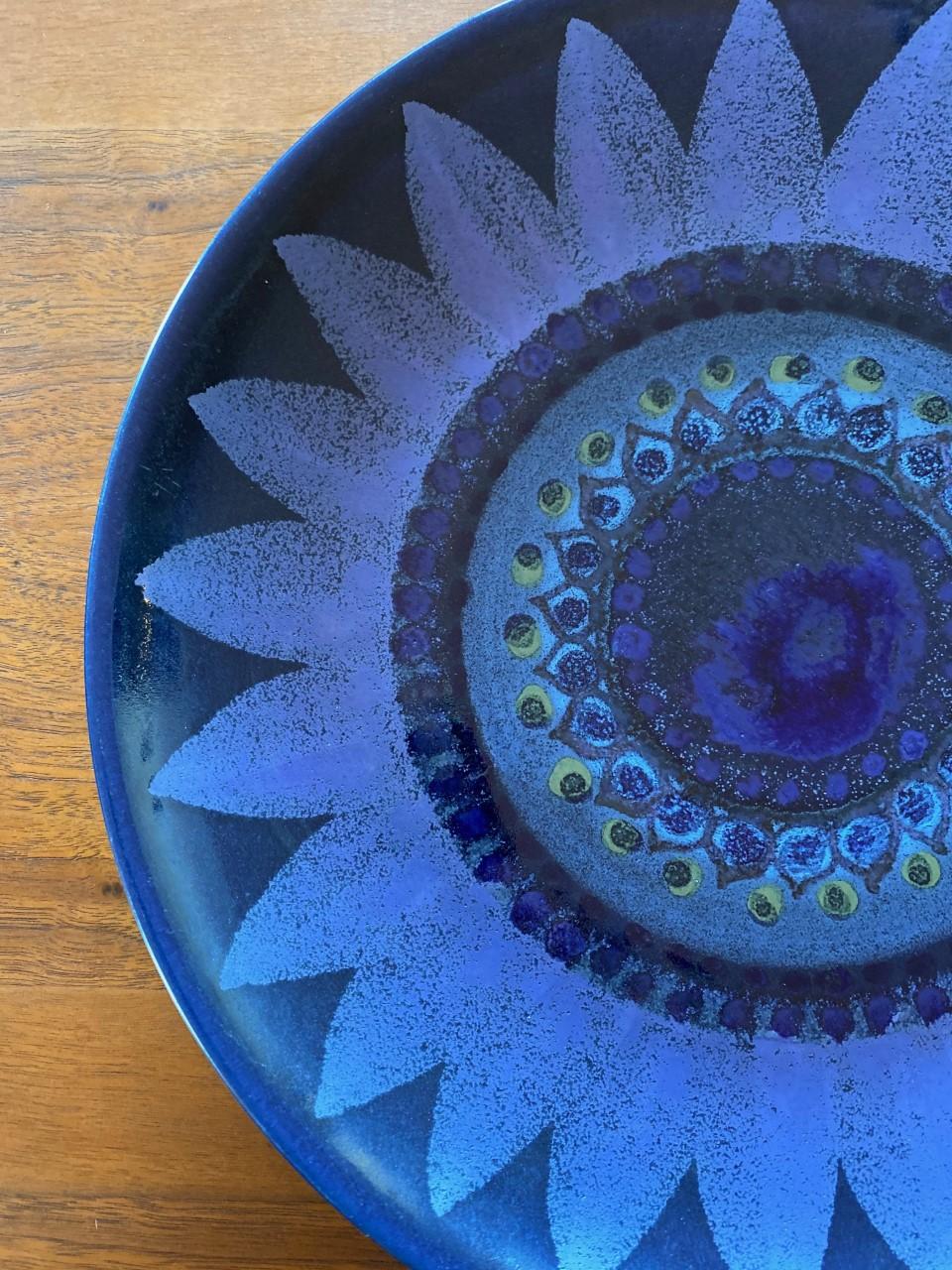 Beautiful vintage ceramic platter in a large modernist design by Hilkka-Liisa Ahola (1920-2009) for Arabia. The motif is floral with an array of shades in blue and indigo glaze. Incredible Mid Century signature addition to your style or décor. A