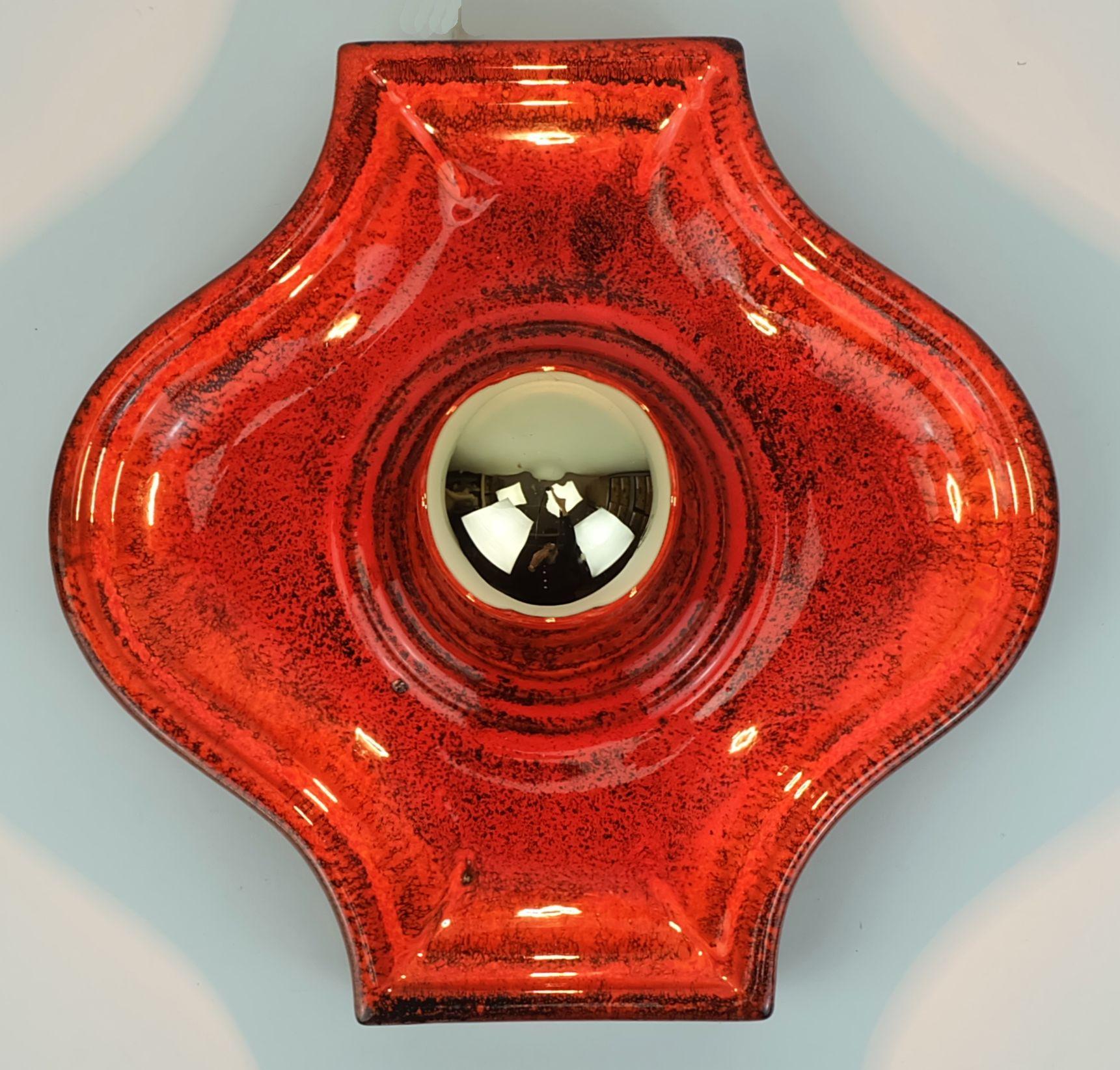 Mid century ceramic wall lamp manufactured in the late 1960s to early 1970s. Shiny glaze in red, orange and black. Holds 1 E27 light bulb (the light bulb in the pictures is not included in the item price). 

Dimensions per lamp in cm: 
Width 26 cm,