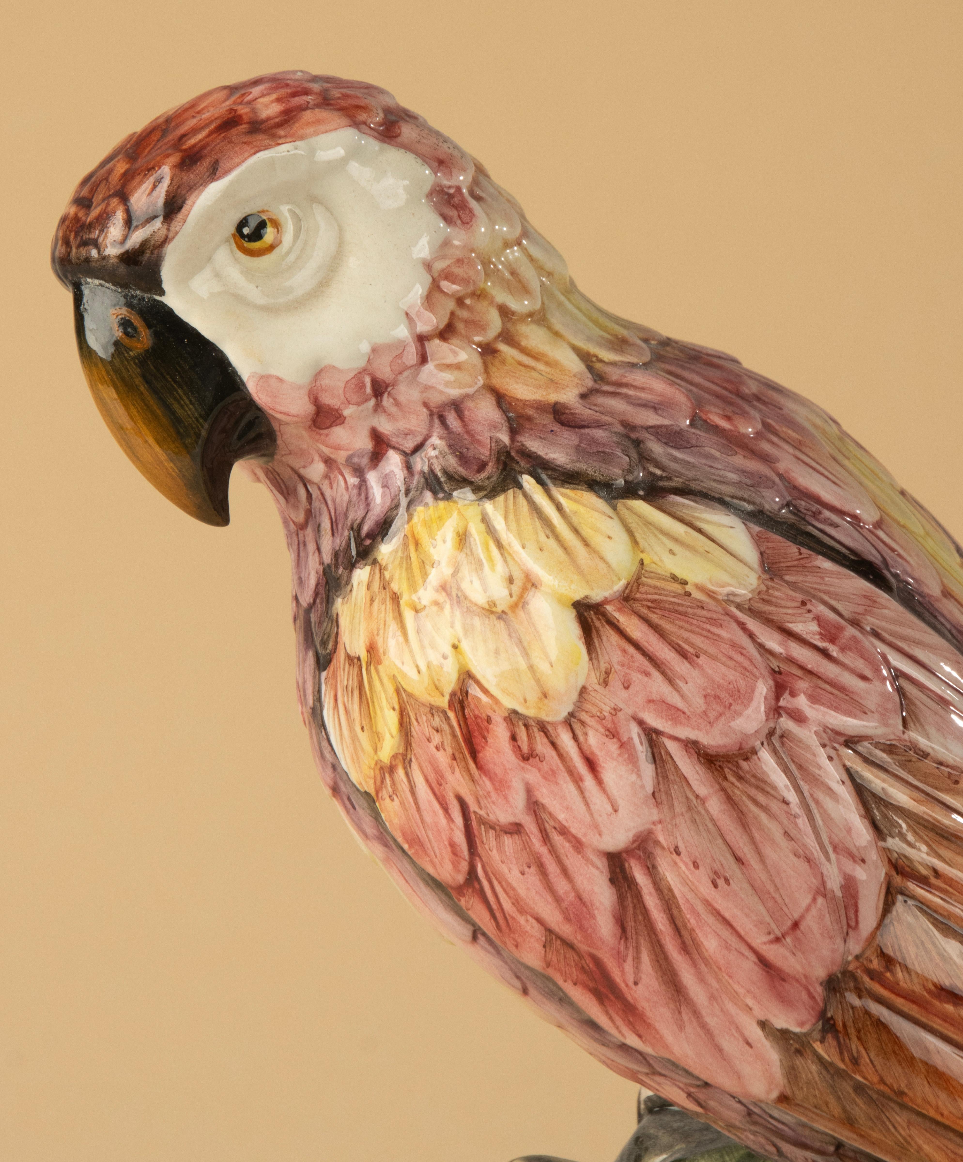 Un bellissimo pappagallo in ceramica di Ronzan, prodotto in Italia, metà del XX secolo. Questa splendida scultura dipinta a mano mostra una squisita maestria, con una forma anatomicamente raffinata e una tavolozza di colori ricca e naturalistica. Le