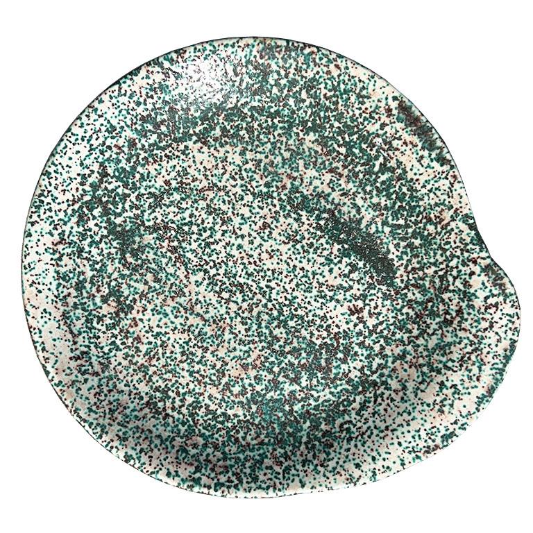 A set of five ceramic splatterware snack plates. Found at the estate of an Oklahoma Rancher, this set is perfect for snacks, or even for cocktail parties. Each plate is round but features a small extended edge on one side for holding with your