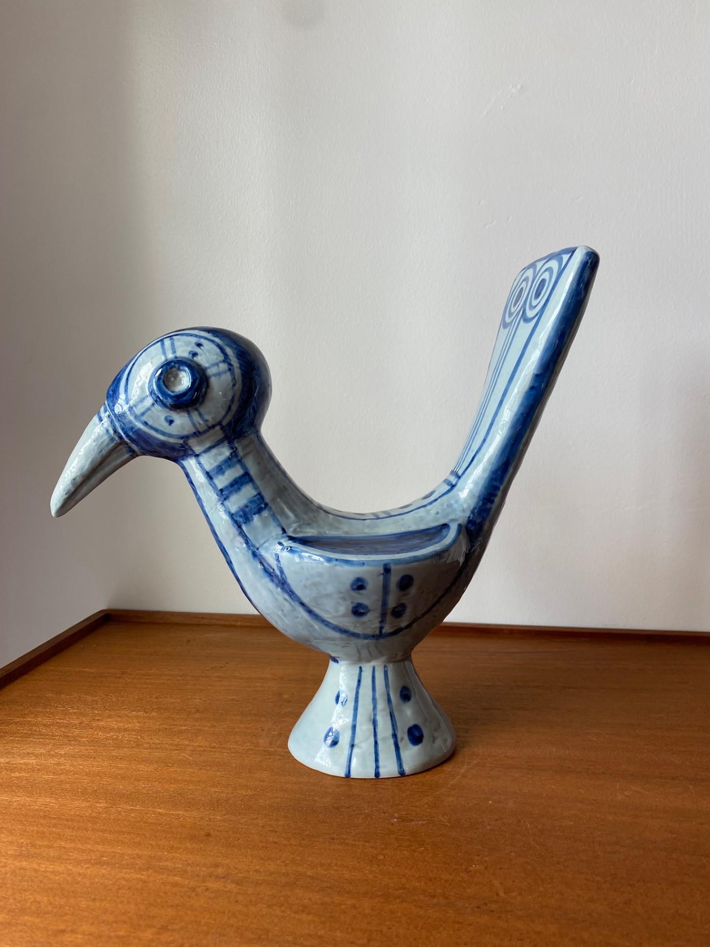 Blue and white Soholm bird designed by Gerd Hiort Petersen, circa 1960-1970. This beautiful ceramic sculpture is captivating and whimsical.  The mesmerizing avian profile with the beautiful glaze and design make this minimalist piece simply