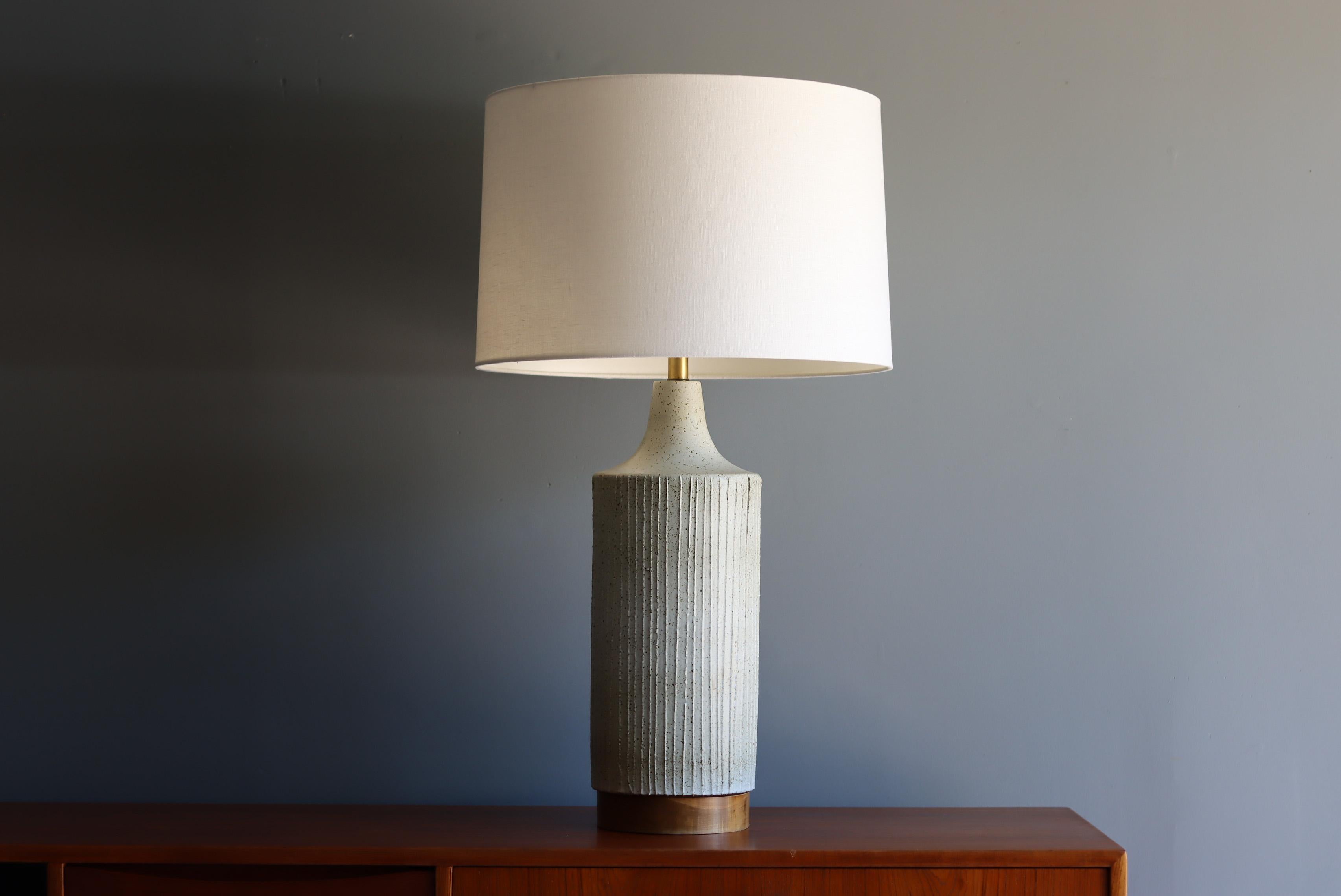 Large scale table lamp by renowned California potter, David Cressey. Produced by Architectural Pottery Pro/Artisan collection. 

This example features a beautiful white glaze with brown and black speckling. Vertical decoration throughout with