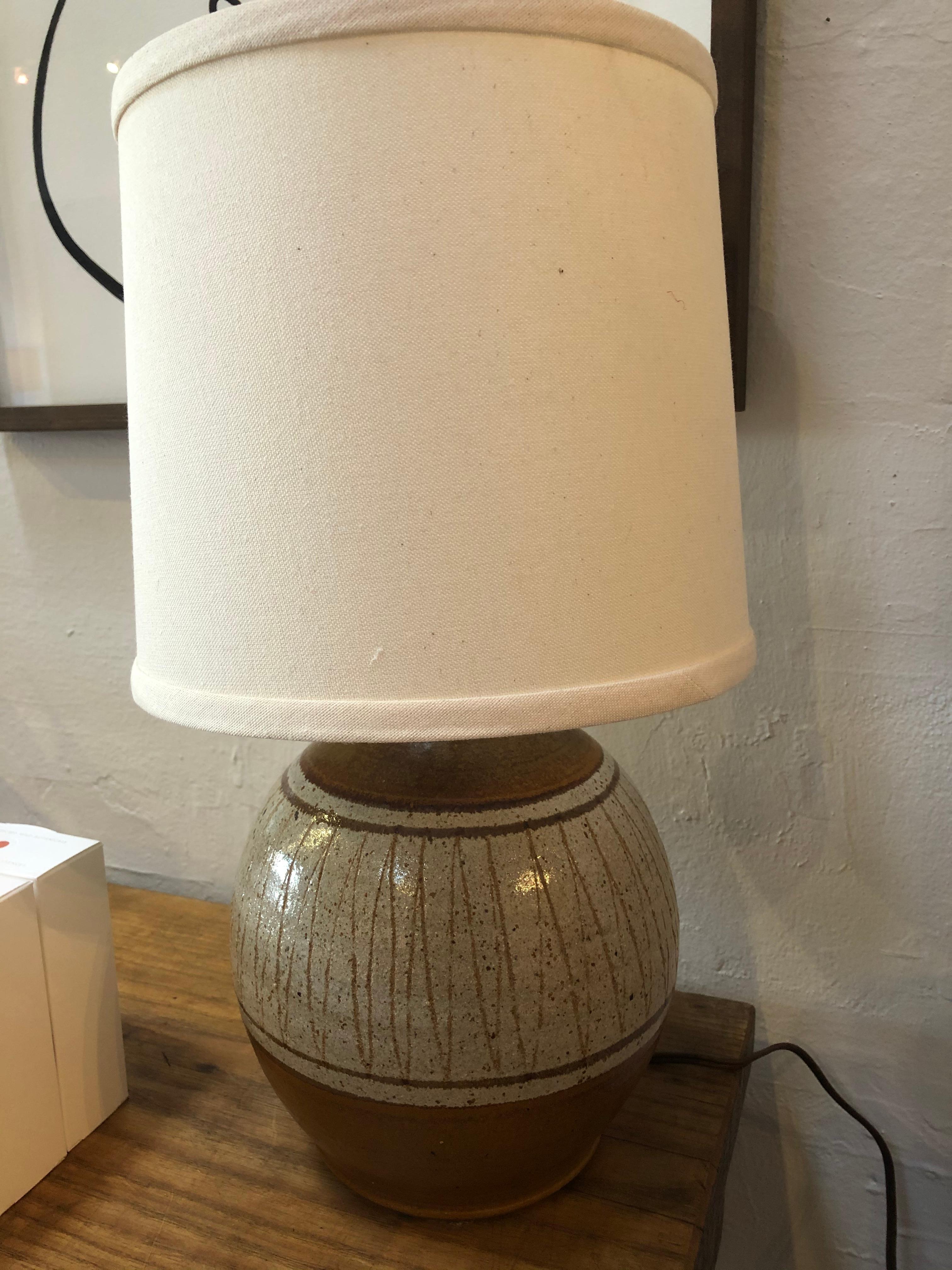 Midcentury ceramic Lamp with linen shade is a great size for end tables, desks, kitchens, offices and so much more. Base is ceramic camel colored glaze with zig zag design around. Cord is 6'8