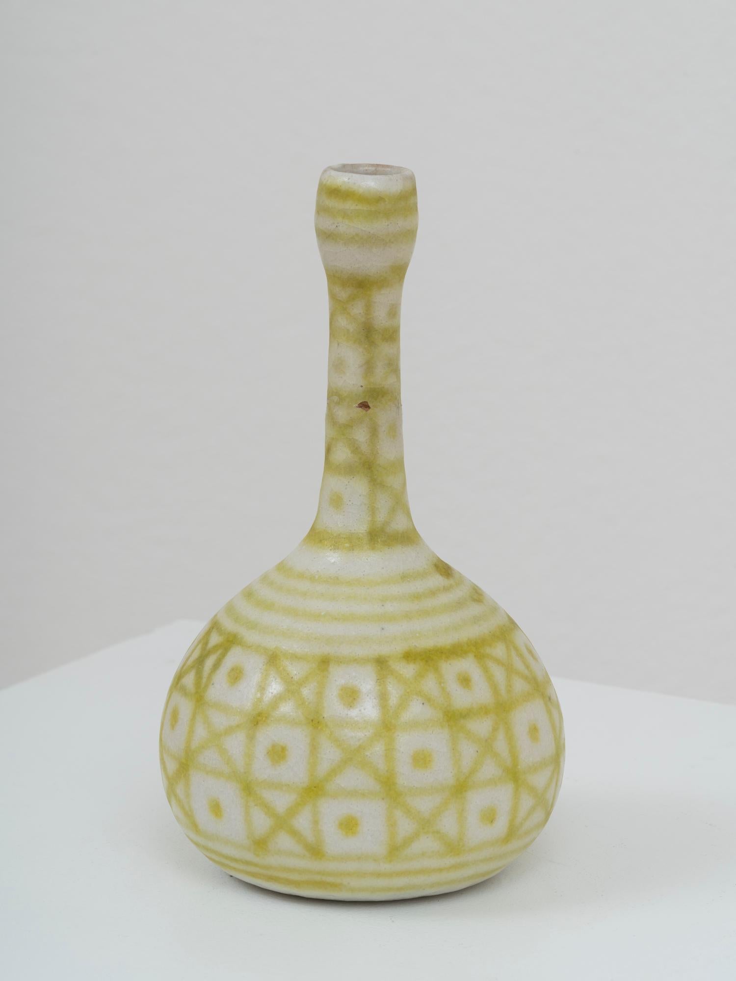 Iconic vase by Italian ceramic master Guido Gambone, from his period at La Tirrena manufacture, active between 1950 and 1967. It is signed with his surname and the iconic donkey mark at the bottom. This vase features a striking geometric decor in a