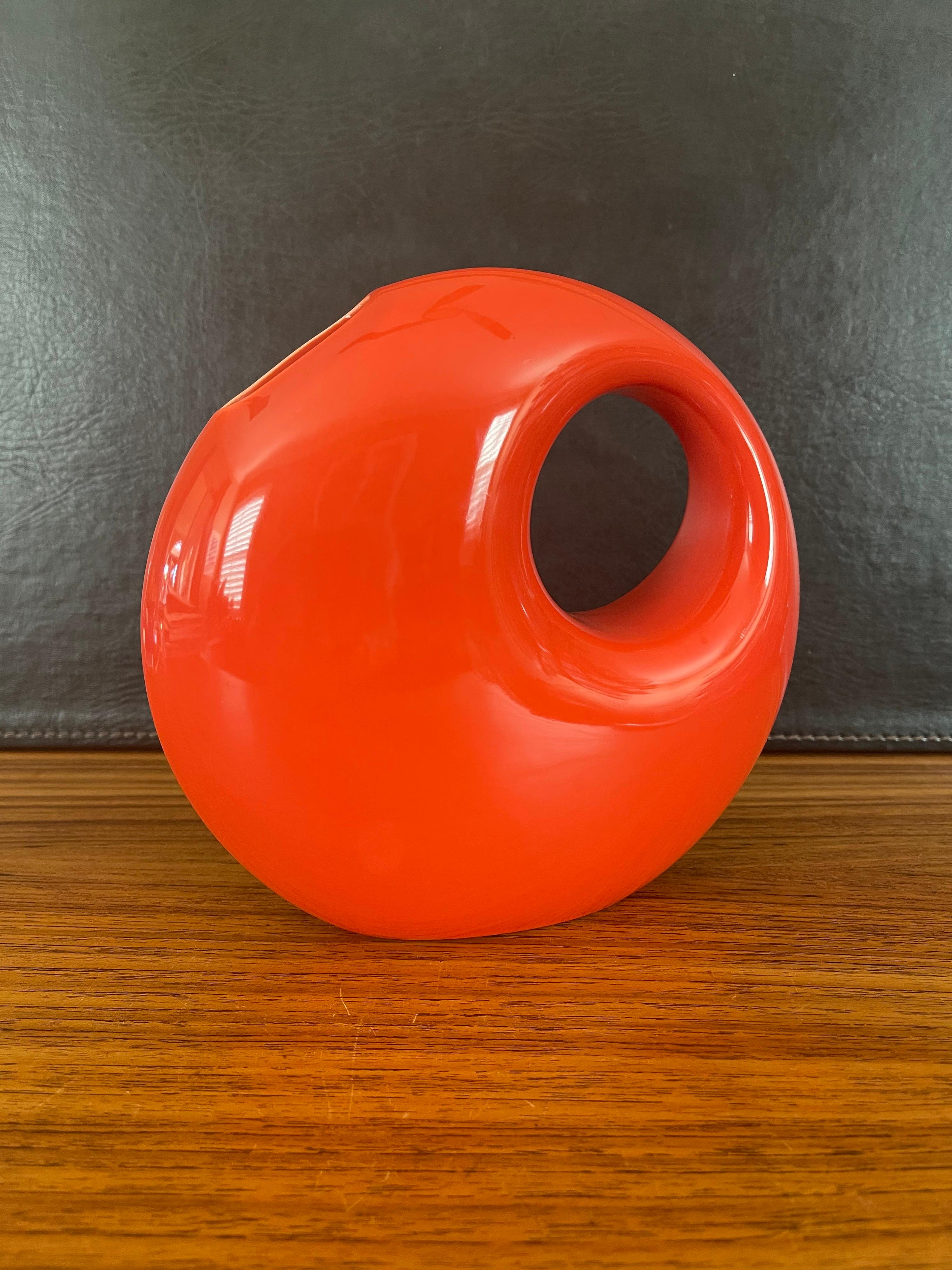 A very cool midcentury ceramic vase by Les Heritiers for Roche Bobois, circa 1970s. The circular vase is a very cool glossy bright orange and measures 8.75