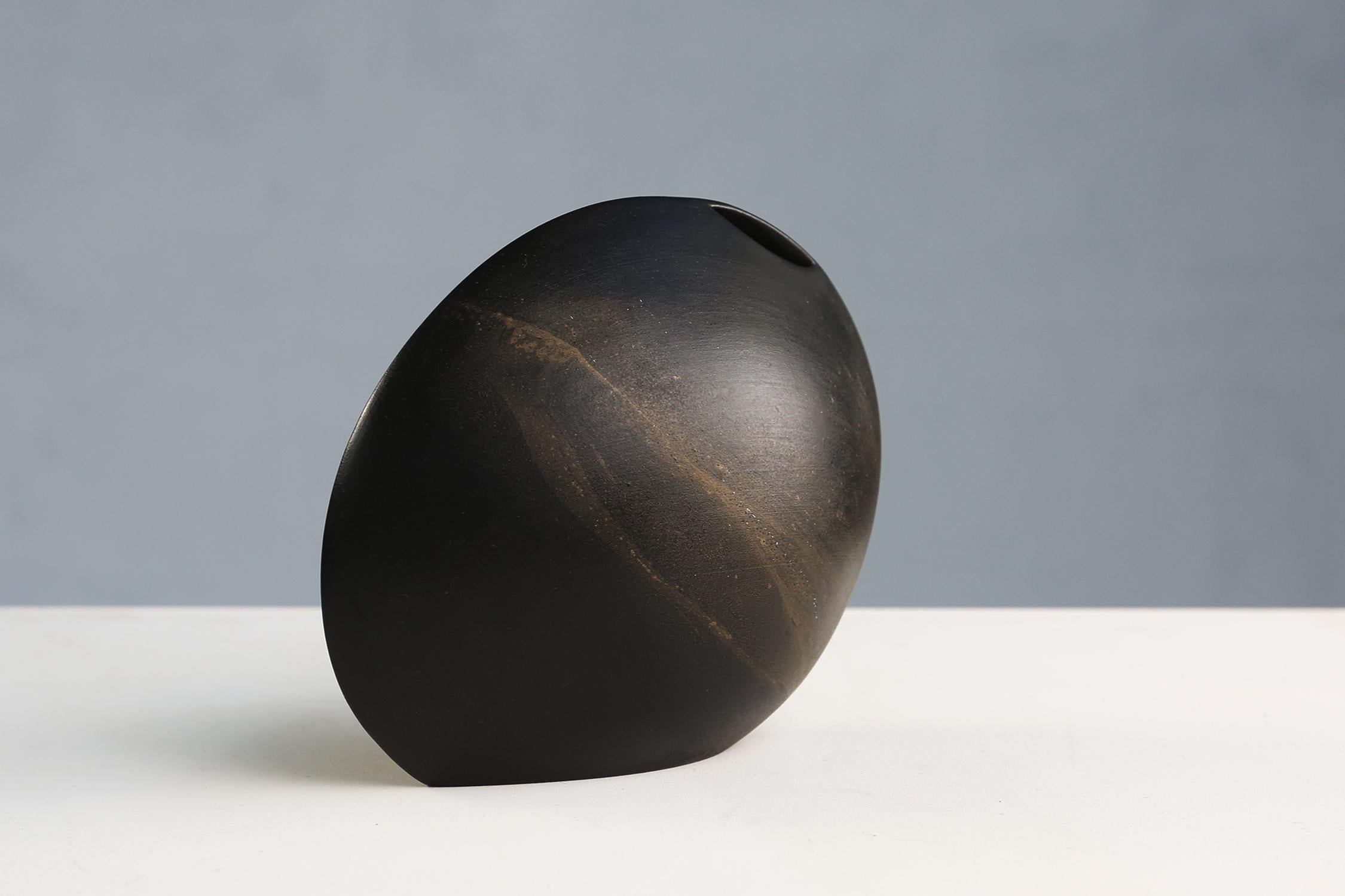 Black ceramic oval vase made around 1960.