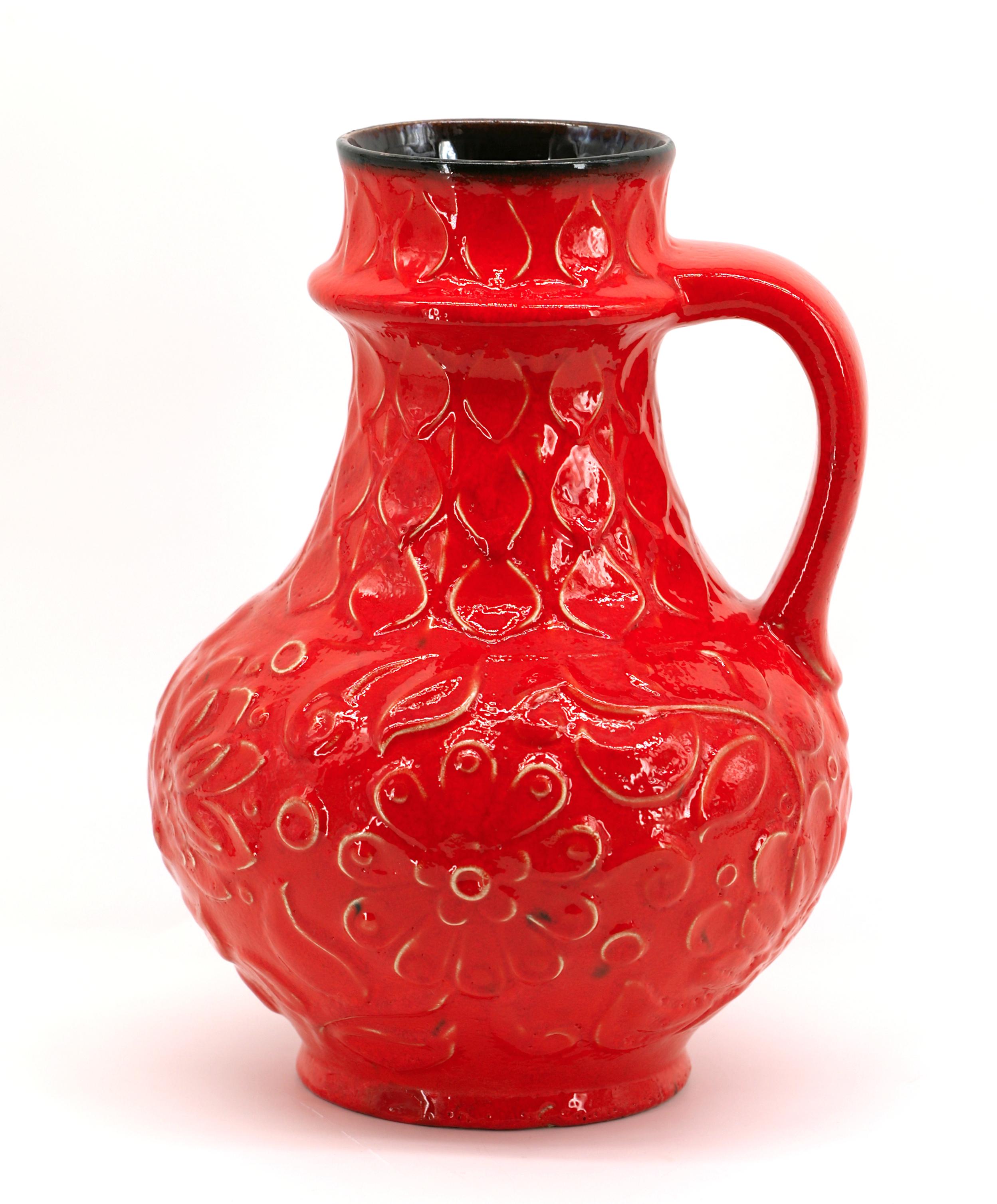German Mid-century ceramic vase, Germany, 1950s. Vase with a handle. Fantastic red color on a cameo floral decoration typical of the 50s. Height : 30cm - 11.8 in. , Diameter : 22cm - 8.7 in. Marked 