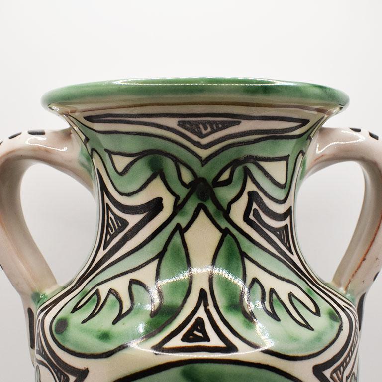 A tall vintage ceramic one-of-a-kind vase by Spanish artist Domingo Punter Teruel. This lovely piece is decorated and glazed in geometric designs green, black, and cream. It features a decorative handle on each side and is signed by the artist at