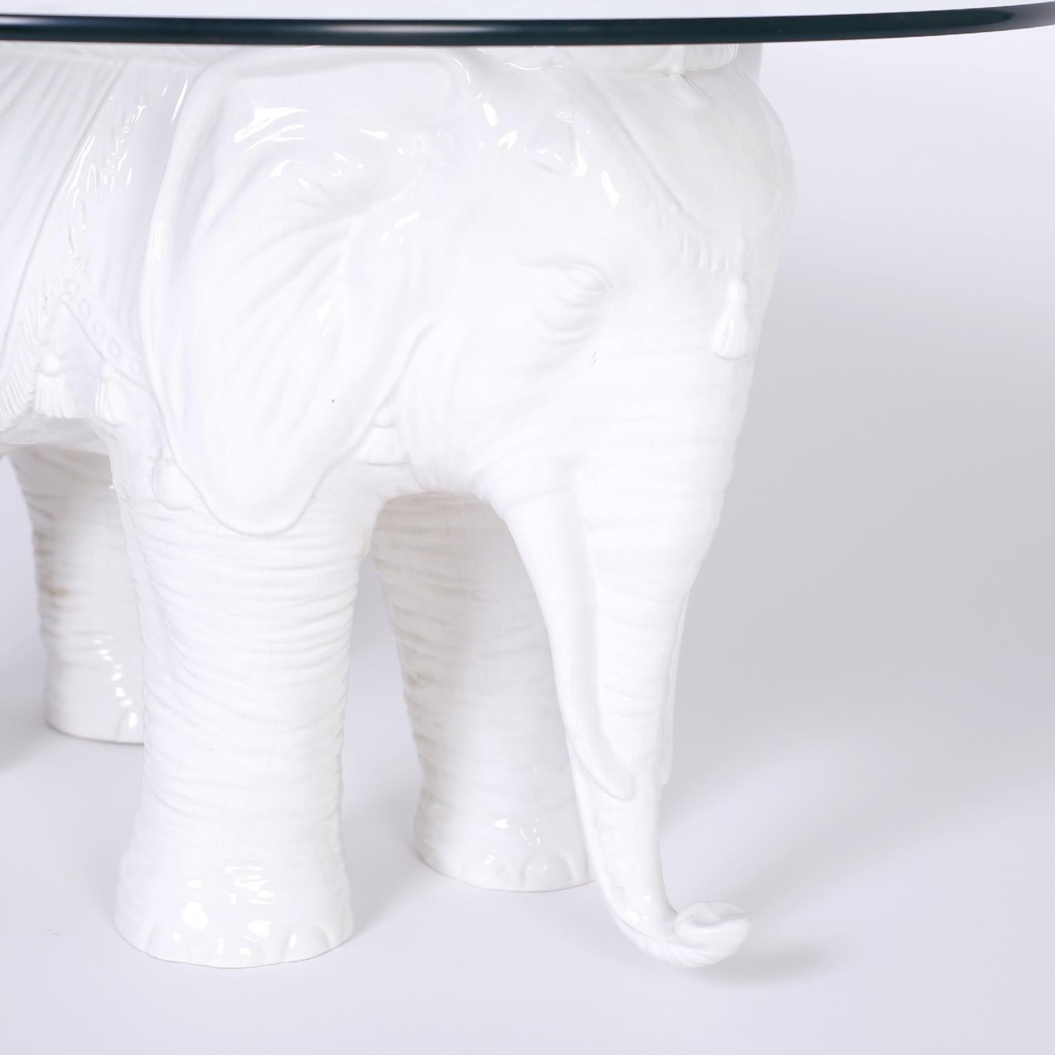 British colonial style Italian ceramic coffee or occasional table with a round glass top and a white glazed elephant base. Signed 
