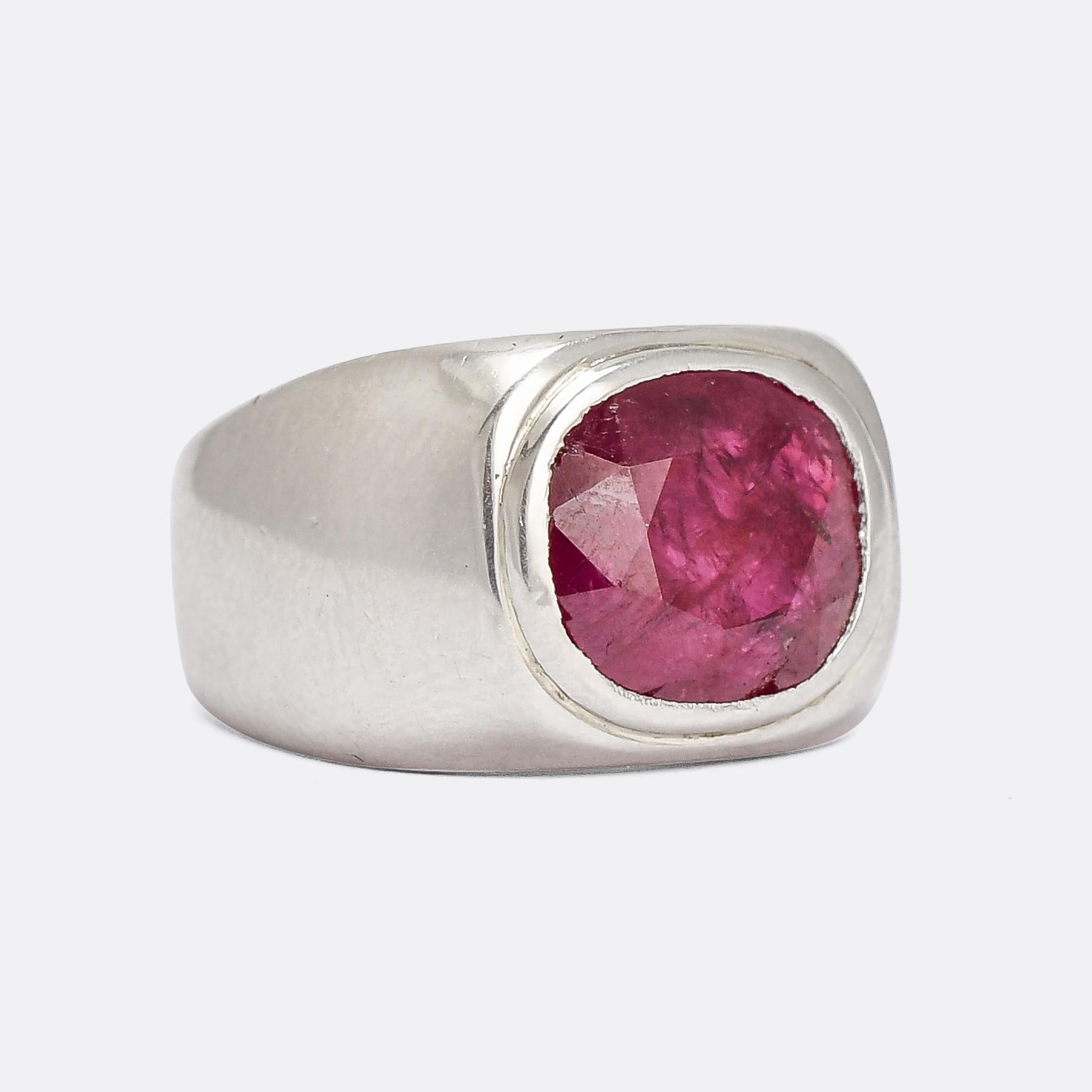 An incredibly Mid Century Modern signet ring set with a cushion cut no-heat Burma ruby, certified at 5.59 carats. The quality of the mount, likely created as a gents ring originally, reflects the quality of the stone: it's platinum throughout and