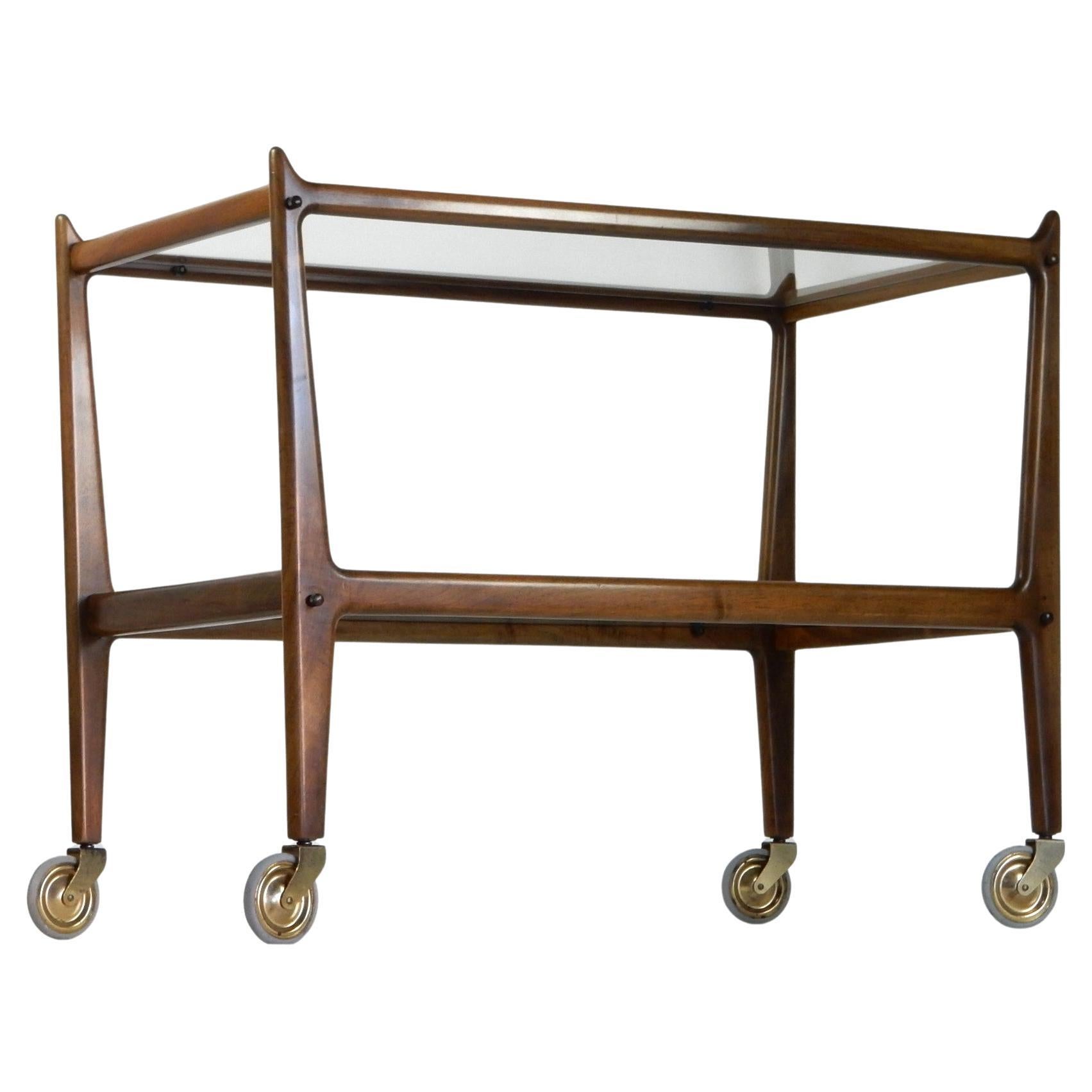 Stunning 1950's serving cart attributed to Cesare Lacca of Italy.
Sleek sculptural design in Walnut with brass accents.
Exceptional, all original condition. 
This will be disassembled and carefully packed for shipping.
