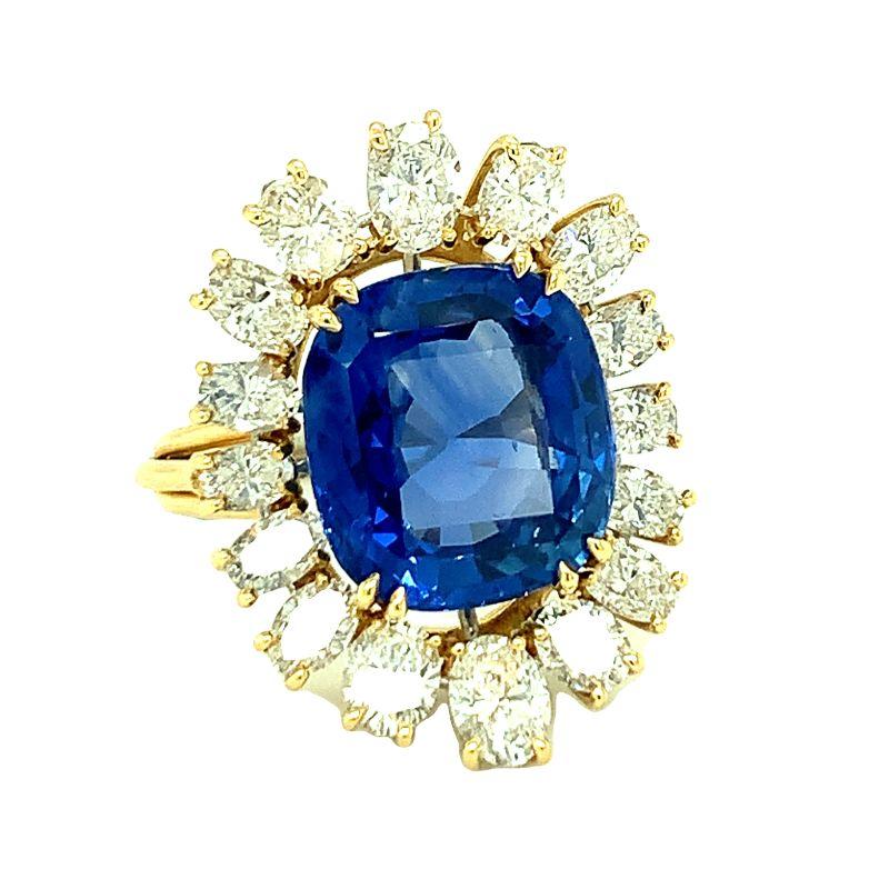 One mid-century ceylon sapphire and diamond 14K yellow and white gold ring centering one prong set, cushion modified brilliant sapphire weighing 11.22 ct. with AGL Certificate No. 1085182 stating no heat and ceylon origin. Enhanced by 16 oval