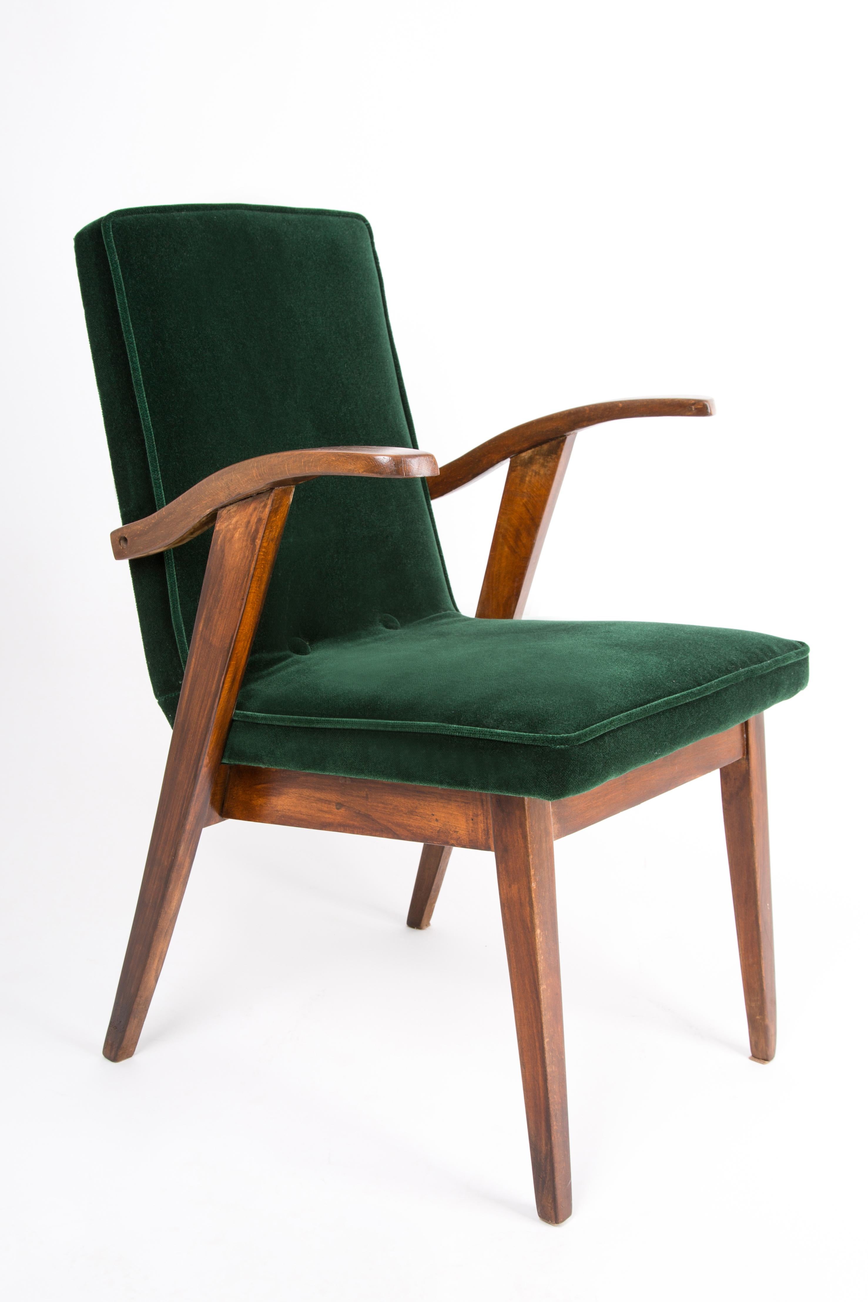 Armchair designed by Mieczyslaw Puchala in a classic edition. Dark wood combined with a green fabric gives it elegance and nobility. The chair has undergone a full carpentry and upholstery renovation. The wood is in excellent condition, finished