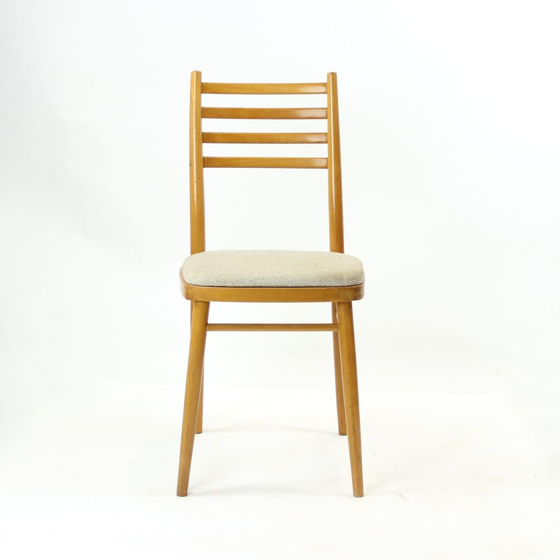 Great single chair in typical midcentury design. Produced out of oak wood in blond stain. Beautiful design features and details. The seat is upholstered in an original fabric in light cream & straw color. Elegant design. Produced by Drevounia fabric