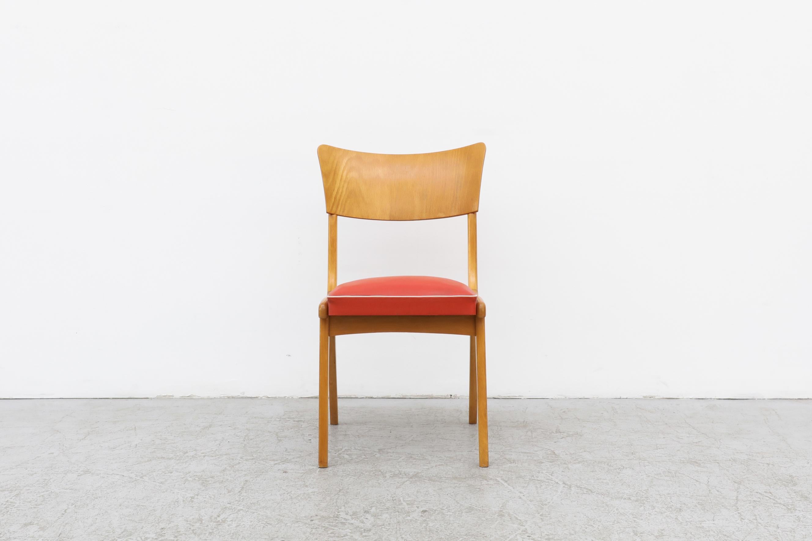 Midcentury chair with curved seat back, blonde frame and an adorable red vinyl seat and white trim. In original condition with visible surface scratches on the wood and a patina to the vinyl. The wear is consistent with its age and use. Other single