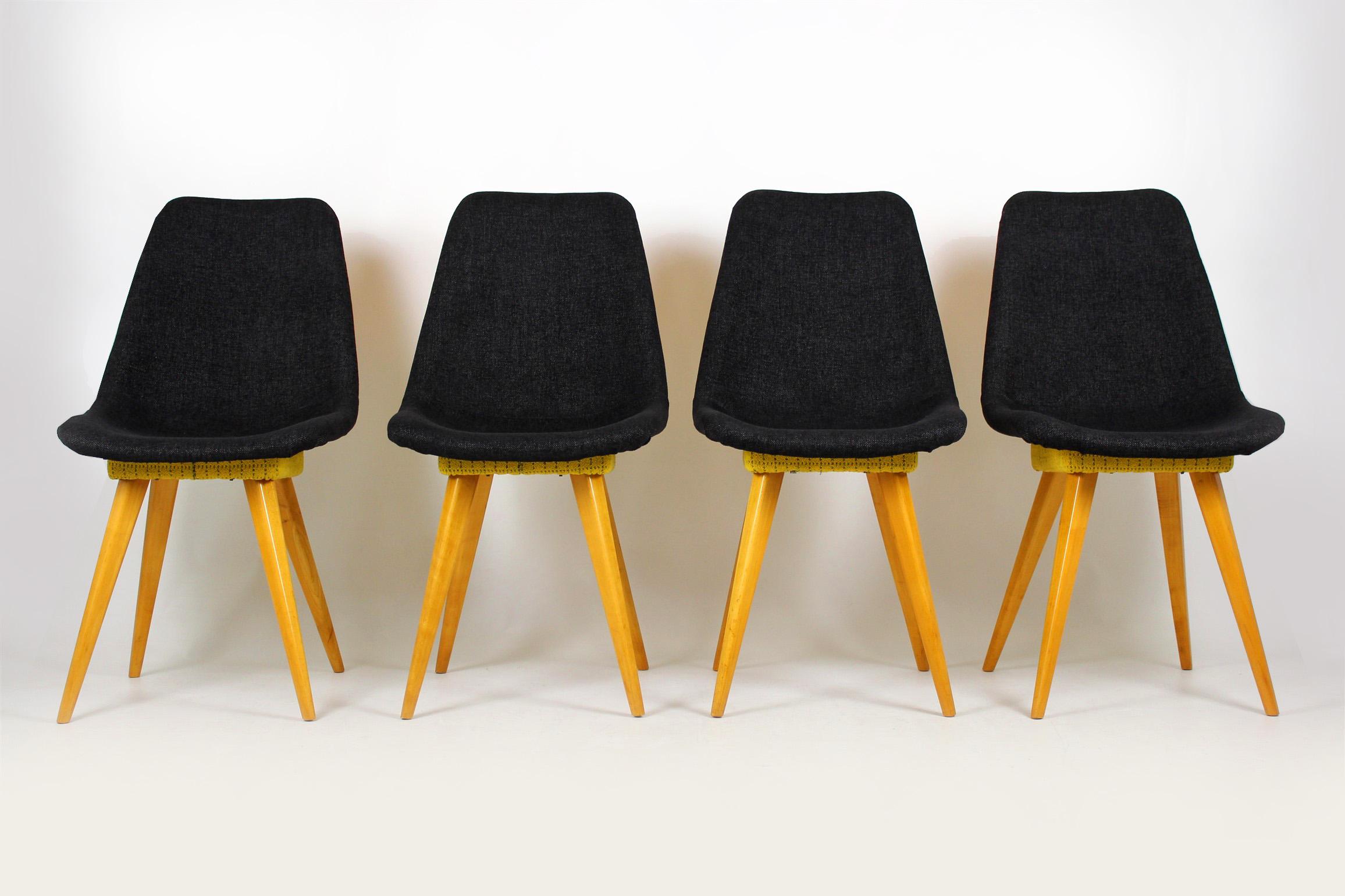 Set of four chairs from Drevovyroba Ostrava. Produced in 1960s in former Czechoslovakia. Seats upholstered with new dark grey fabric upholstery, yellow fabric is an original from the 1960s, preserved very well.