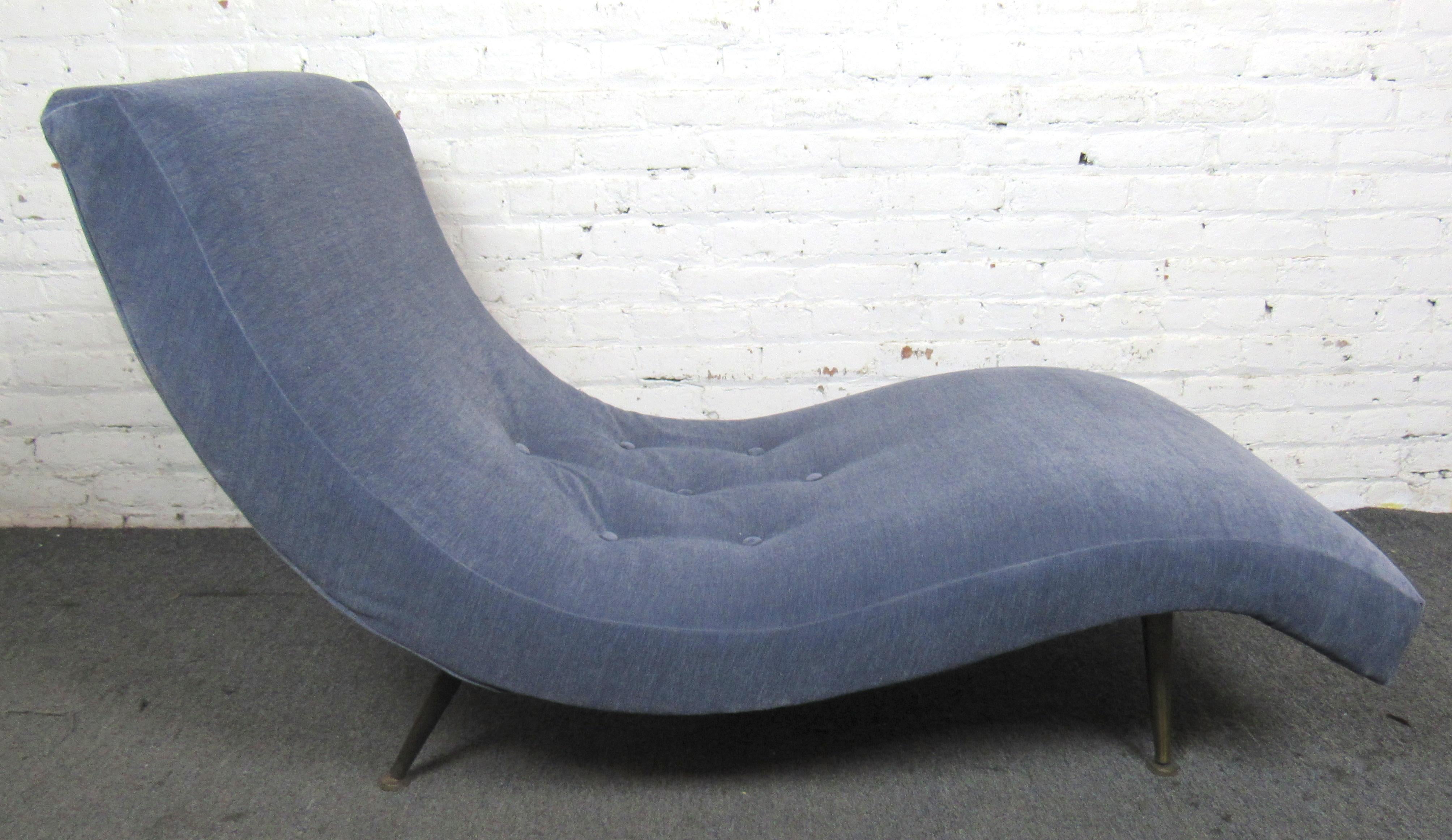Bring home a mid-century modern legend with this vintage Adrian Pearsall design. The wavy silhouette is sure to bring the rest and relaxation of the beach into your living room.  Reupholstered by its last owner, this robust chaise is sure to hold up