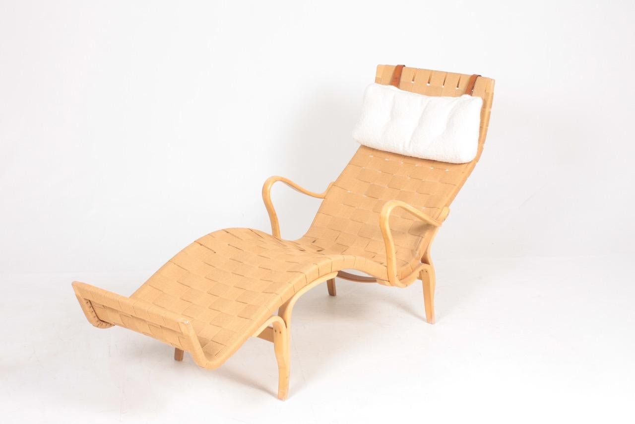 Bruno Mathsson lounge chair with original hemp webbing. Seat frame, arms and under frame of laminated beech. Produced by Firma Karl Mathsson, made in 1973. Great original condition

Bruno Mathsson was born to cabinet making. His father, Karl