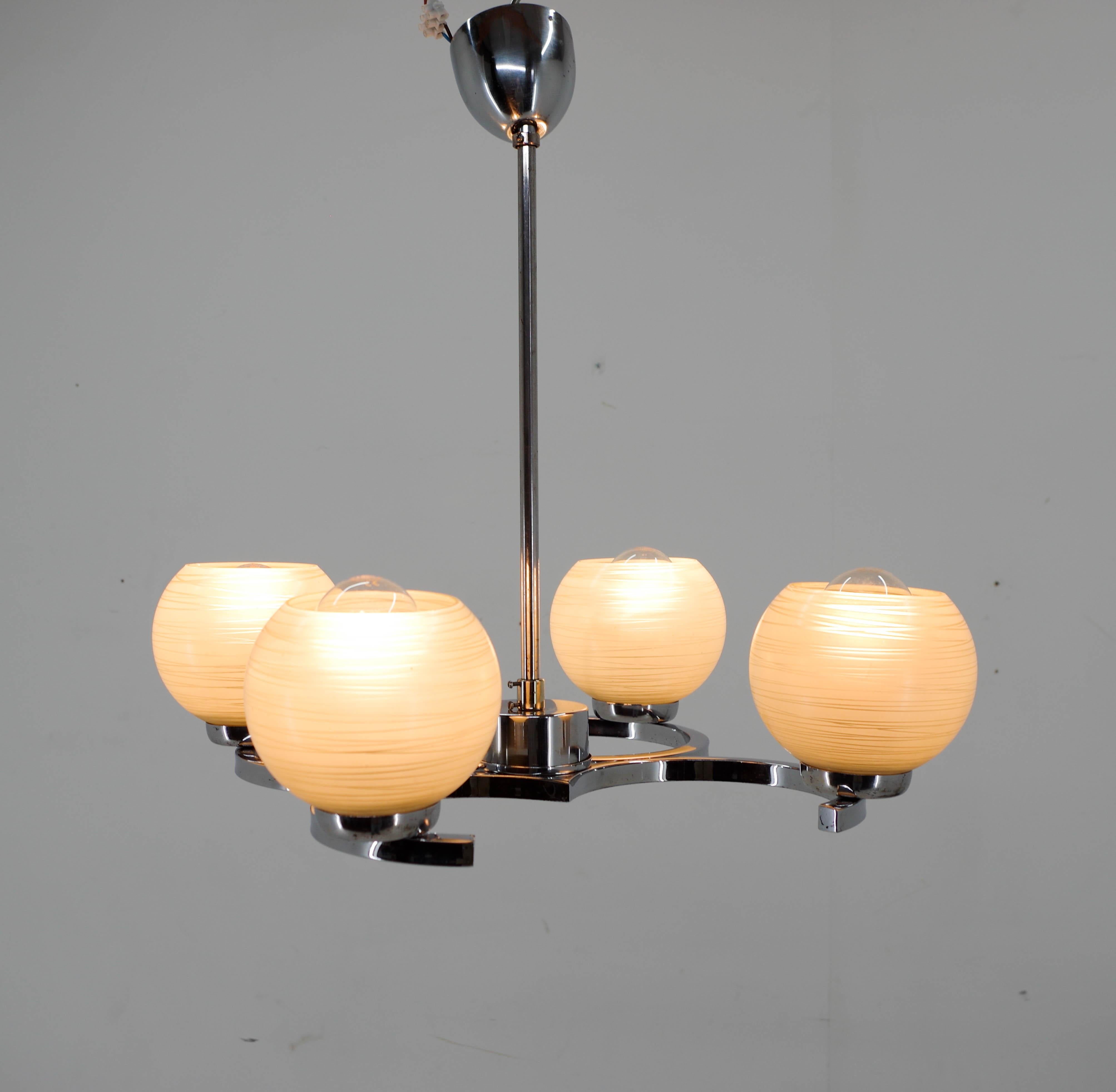 4-flamming chandelier made by Napako in Czechoslovakia in 1950s.
Glass in perfect condition, chrome with minor age patina.
Cleaned, polished, rewired: 4x40W, E25-E27 bulbs
US wiring compatible
