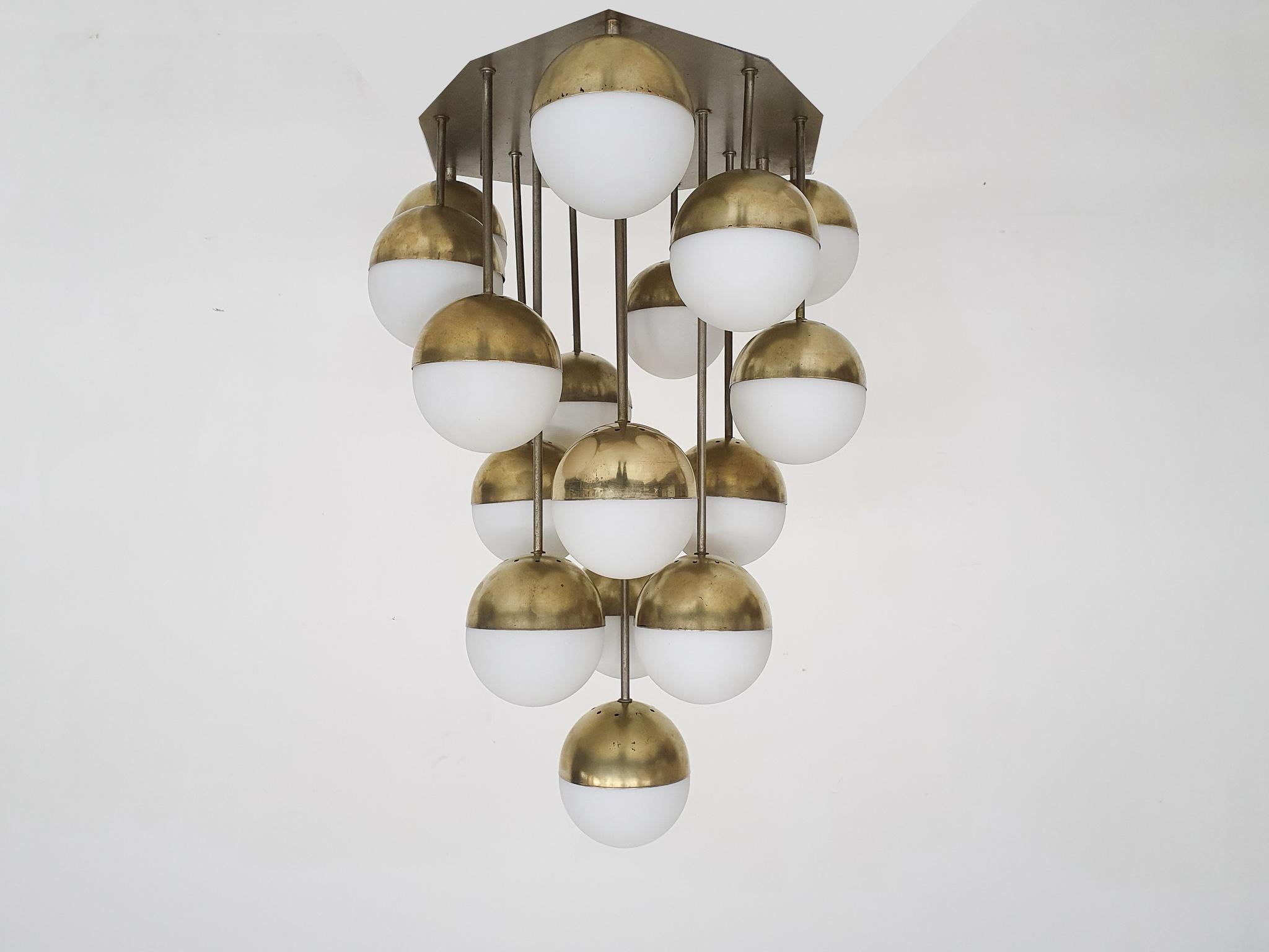 Large impressive chandelier by Stilnovo, Italy 1960's

The lamp consist of a metal ceiling plate with 16 brass and opaline glass globes.
We have checked the lamp and renewed all the fittings, the wires were already replaced once.
The brass globes
