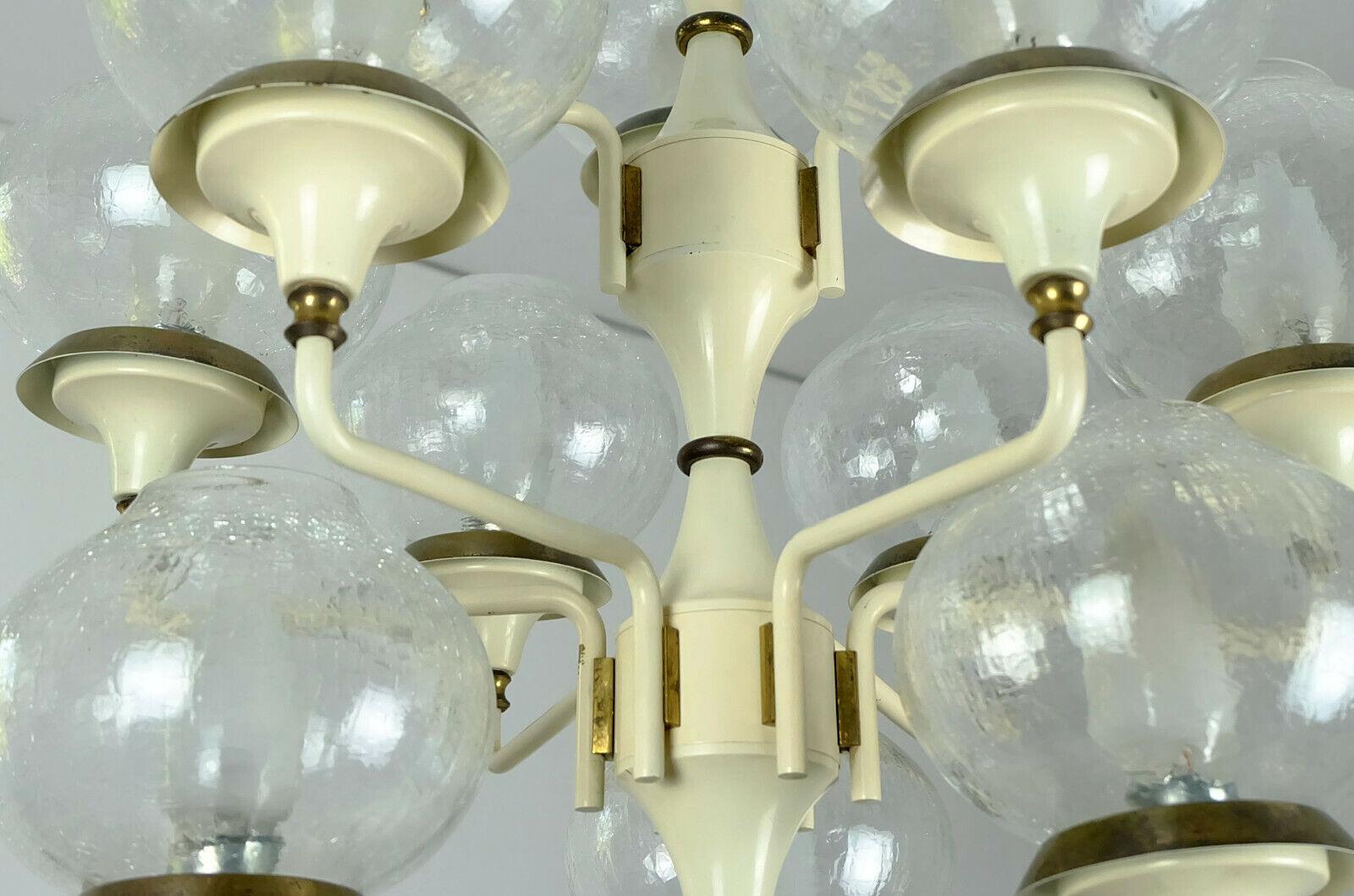 1960s midcentury hanging lamp made of light beige lacquered metal and brass with 12 glass shades. It works with 12 E14 bulbs. 

Good condition, minor traces of age on the brass and lacquering parts. The glass is in very good condition. We