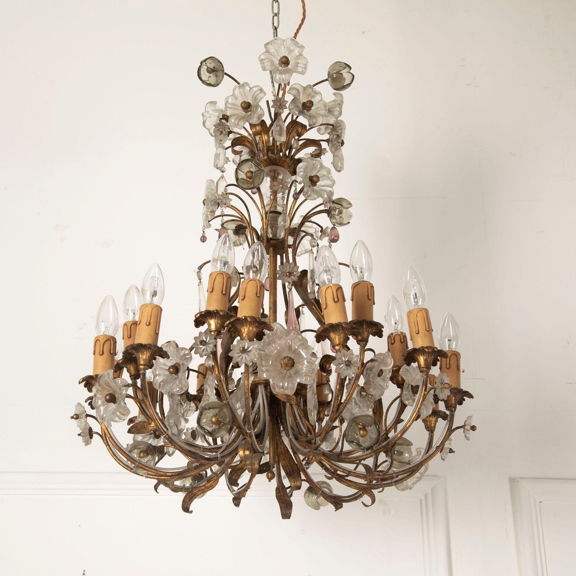 Lampadario di metà secolo con struttura in metallo dorato e petali in vetro.
Questo splendido pezzo ha 18 steli, decorati con un mix di gocce di vetro trasparente e colorato.
È stata ricablata secondo gli standard del Regno Unito e offre il massimo
