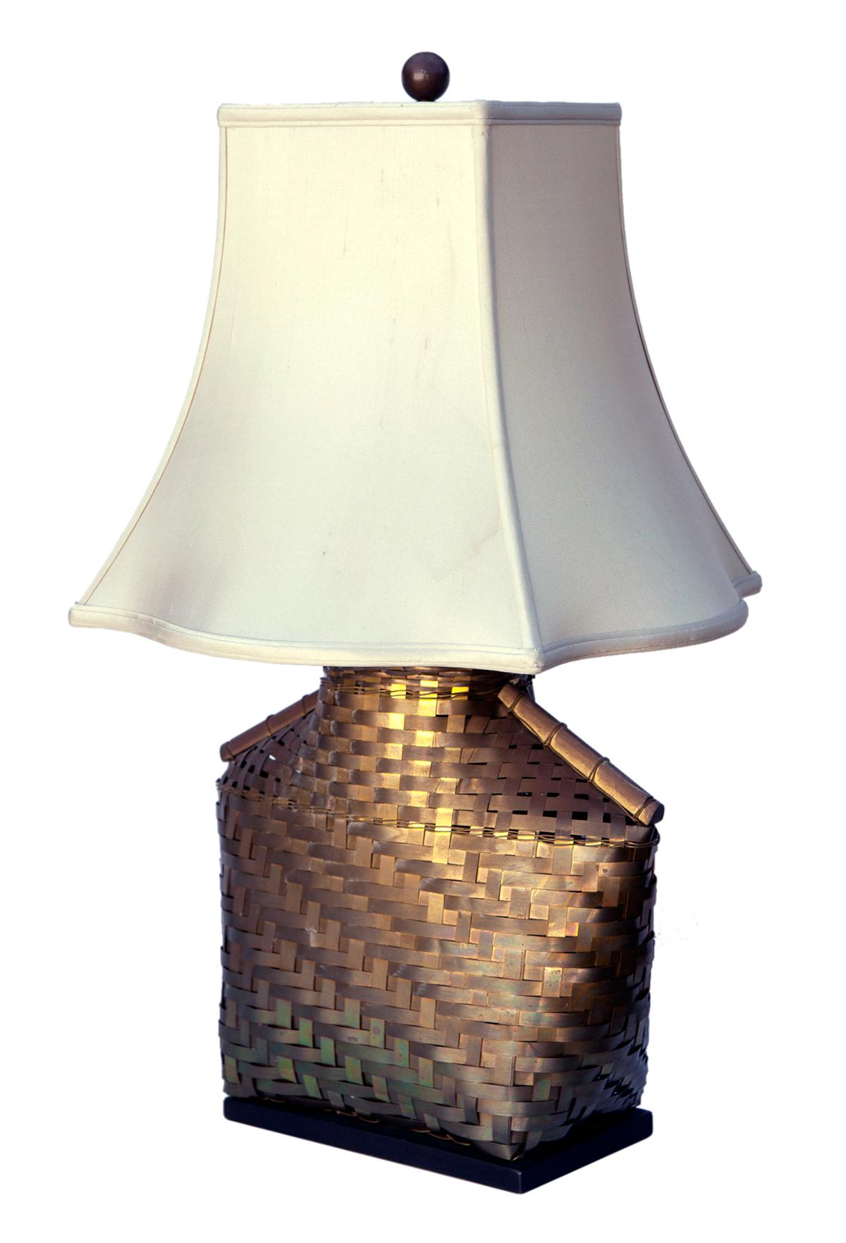 Asian inspired, mid century Chapman table lamp in handwoven brass, which sits on an ebony base.
Paired with an aftermarket shade, which is not in perfect condition, see pictures for details