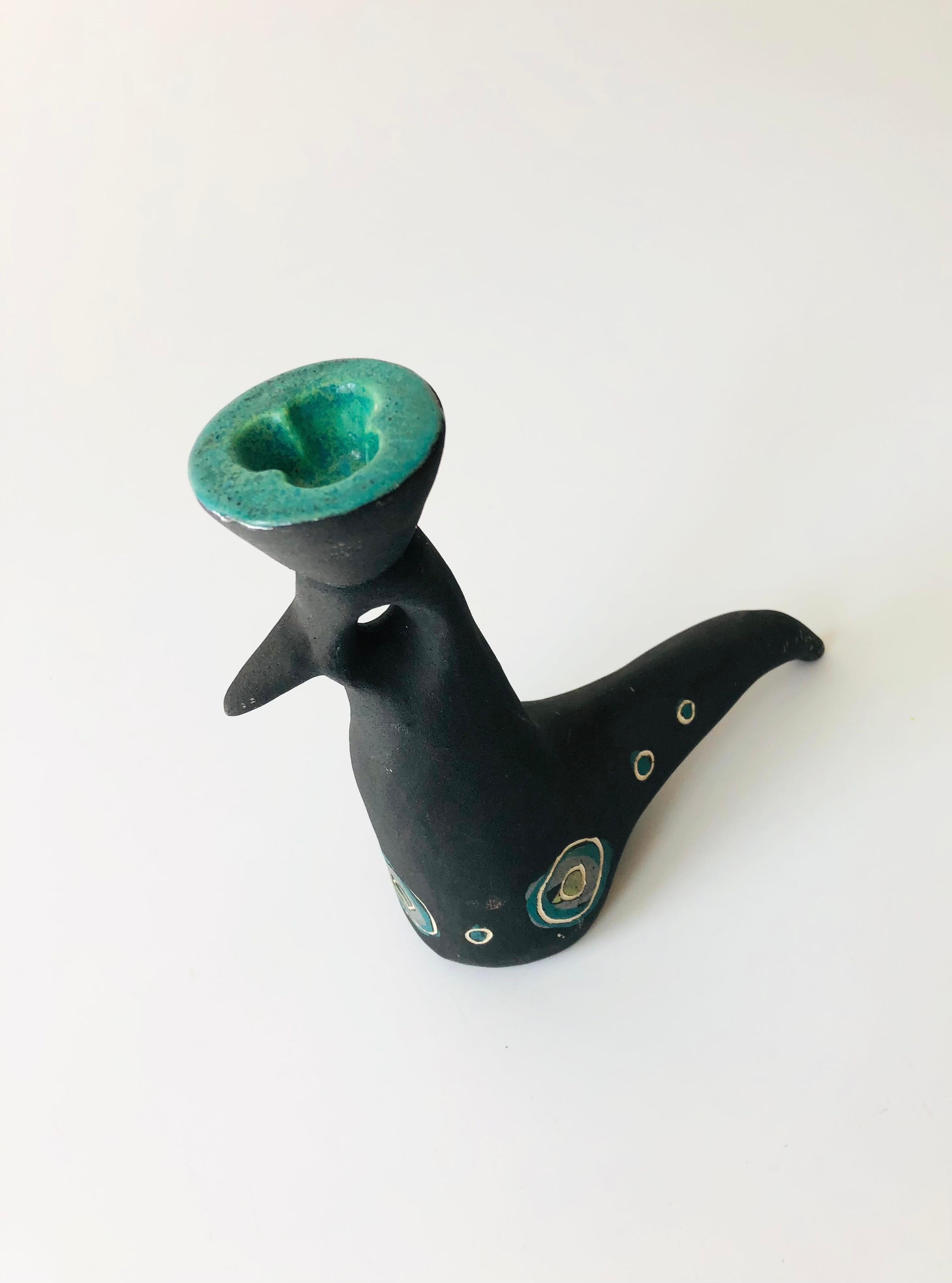 A midcentury Studio Pottery candle holder in the shape of a bird from the 1940s-1950s by husband and wife ceramicists, Charles and Alice Smith of California. Wonderfully quirky shape to the bird. Finished in matte black glaze and decorated with