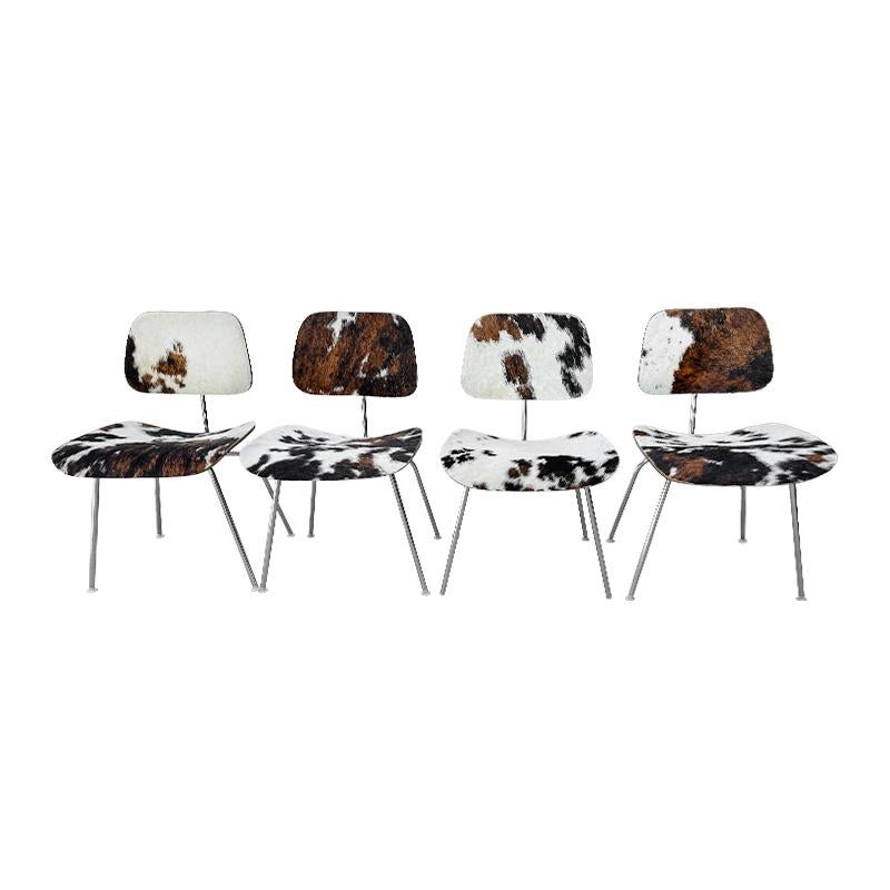 Gorgeous set of 4 Mid- Century Modern  Charles and Ray  Eames Herman Miller  DCM dining chairs in Original Cowhide. Gorgeous tricolor hide in unique patrerns.. Each Chair has some portion of original tag attached to the base.

To view all of  our