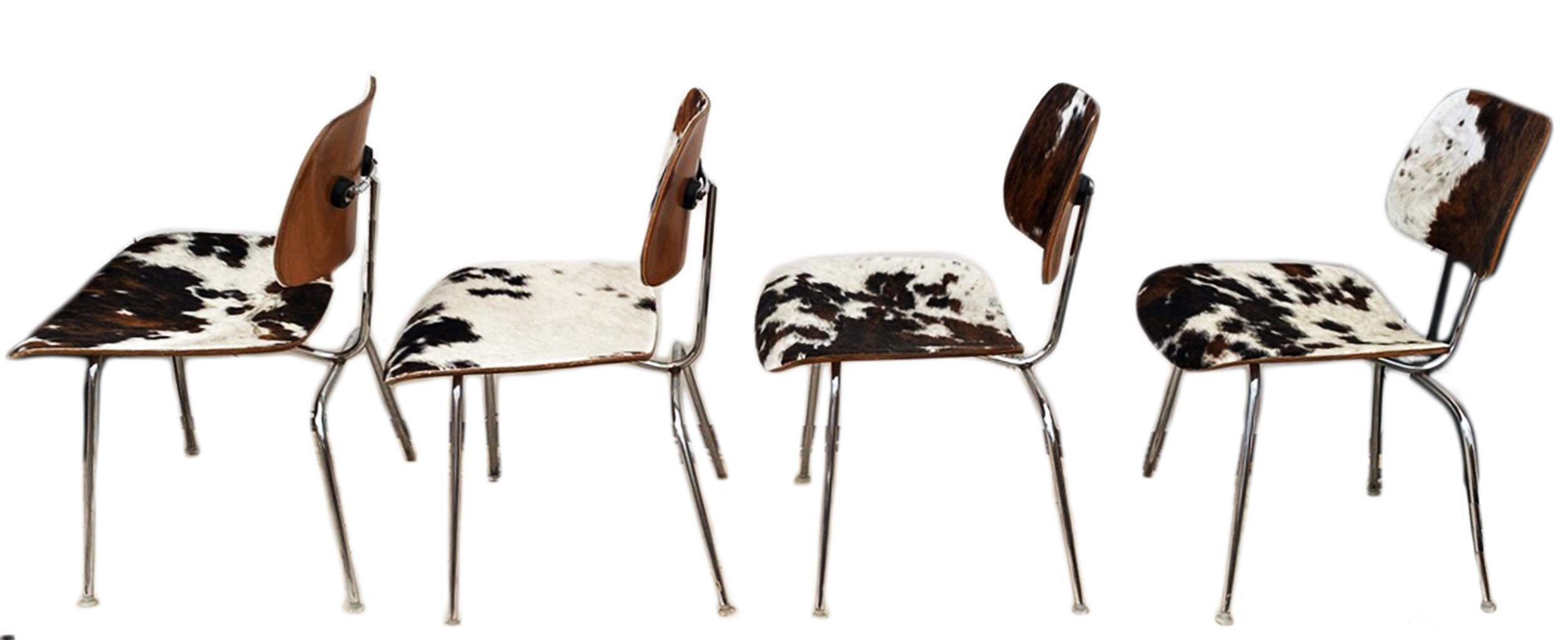 Gorgeous set of 4 Mid- Century Modern  Charles and Ray  Eames Herman Miller  DCM dining chairs in Original Cowhide. Gorgeous tricolor hide in unique patrerns.. Each Chair has some portion of original tag attached to the base.

To view all of  our