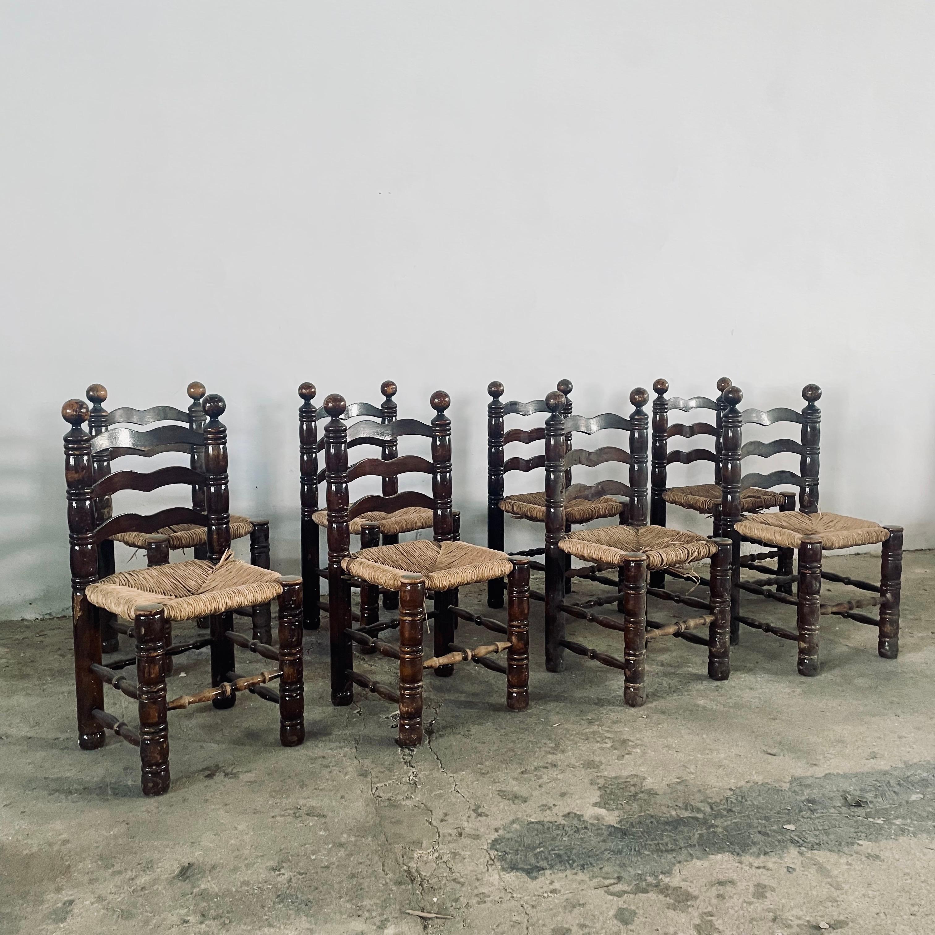 SET of 8 Vintage French Dining Ladder Back chairs in the Style of Charles Dudouyt, circa 1940s 

Natural and original heavy and sturdy oak frames with original worn hand-woven natural rush seats (NEW Rush Seats can be replaced for an additional cost