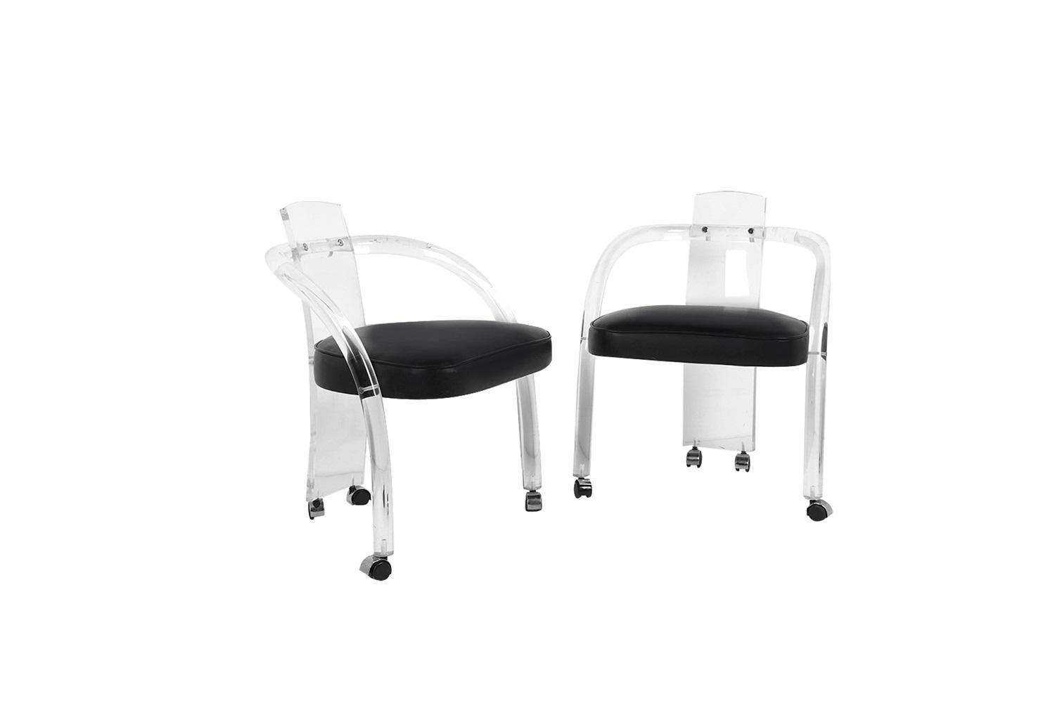 An amazing pair of vintage Mid-Century Modern tubular Lucite chairs, in the style of Charles Hollis Jones. Great modern form featuring a tubular Lucite frame with a barrel backrest. Detailed padded seat cushions, in original black upholstery, and