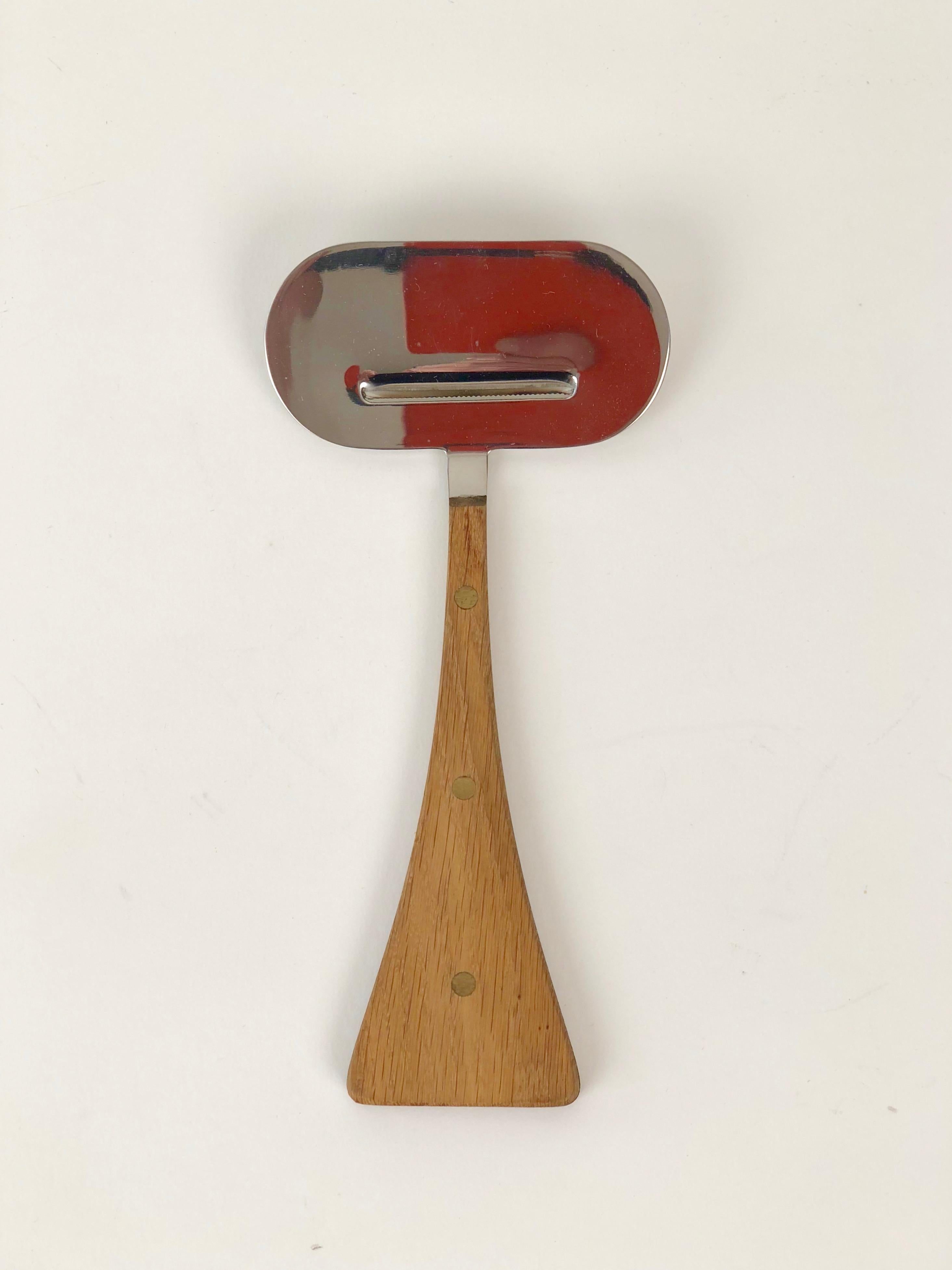 A midcentury cheese slicer designed by Janos Megyik for Amboss Austria. This is boxed set and as one can see, in wonderful condition.
Includes original forged nails for installation on the wall. What a great accessory for a modernist kitchen.