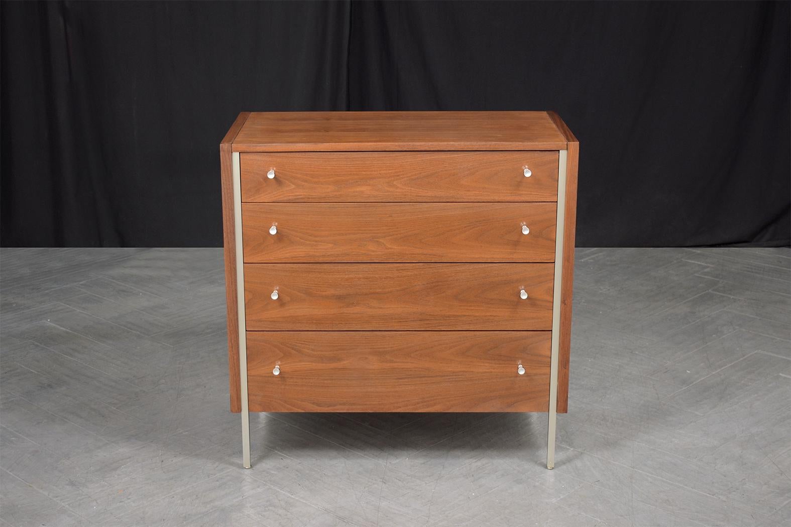 Experience mid-century sophistication with our handcrafted walnut chest of drawers. Expertly restored by our dedicated craftsmen, this premium dresser stands out in any room. Admire the rich grain of the walnut wood, highlighted by a natural stain