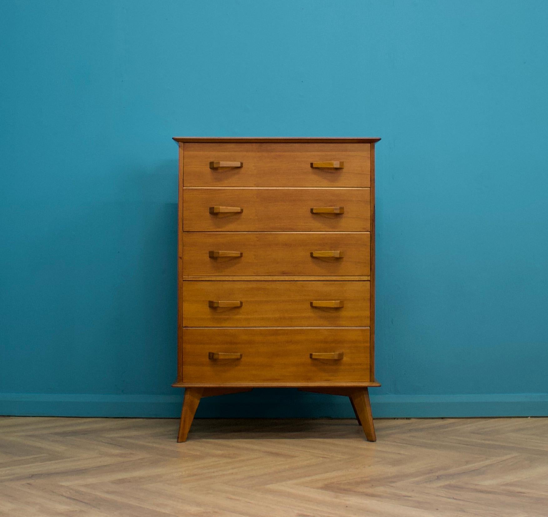 A mid century walnut tallboy chest of drawers from AY Crown Furniture - which is a beautiful quality piece
It's very similar in style and quality to Alfred Cox designed furniture
Standing on splayed legs with five drawers and solid teak handles